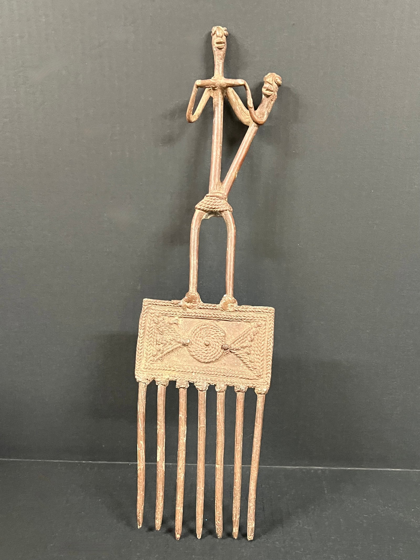 Dogon Bronze Comb: African Tribal Art Dogon Bronze Comb. The dimension is 18.25 inches high x .5 inch depth x 5 inches wide. Please be aware that some of the items are vintage, secondhand, old ages, antiques and may hav