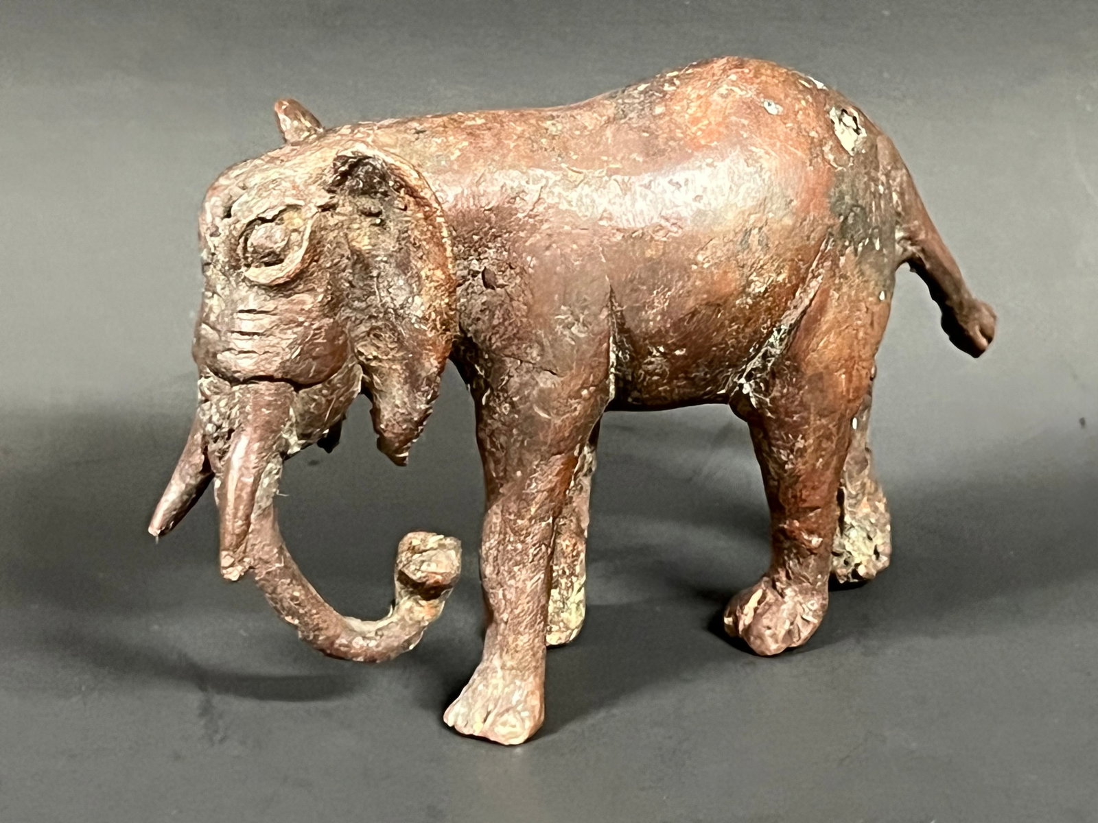 Bronze Elephant Sculpture: African Tribal Art Bronze Elephant Sculpture. The dimension is 3.25 inches high x 1.5 inches depth x 5.25 inches wide. Please be aware that some of the items are vintage, secondhand, old ages, antique