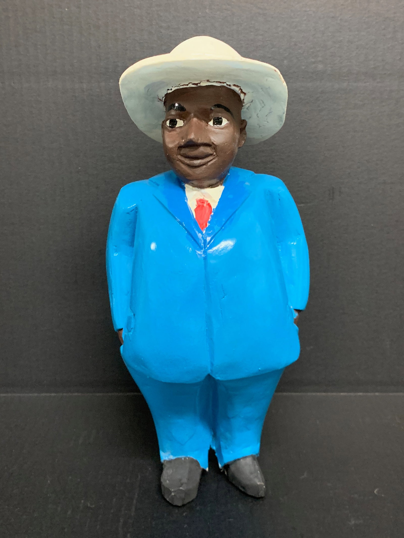 Colonial Male Statue: African Tribal Art Colonial Male Statue. The dimension is 13 inches high x 7.5 inches wide. Please be aware that some of the items are vintage, secondhand, old ages, antiques and may have a defects