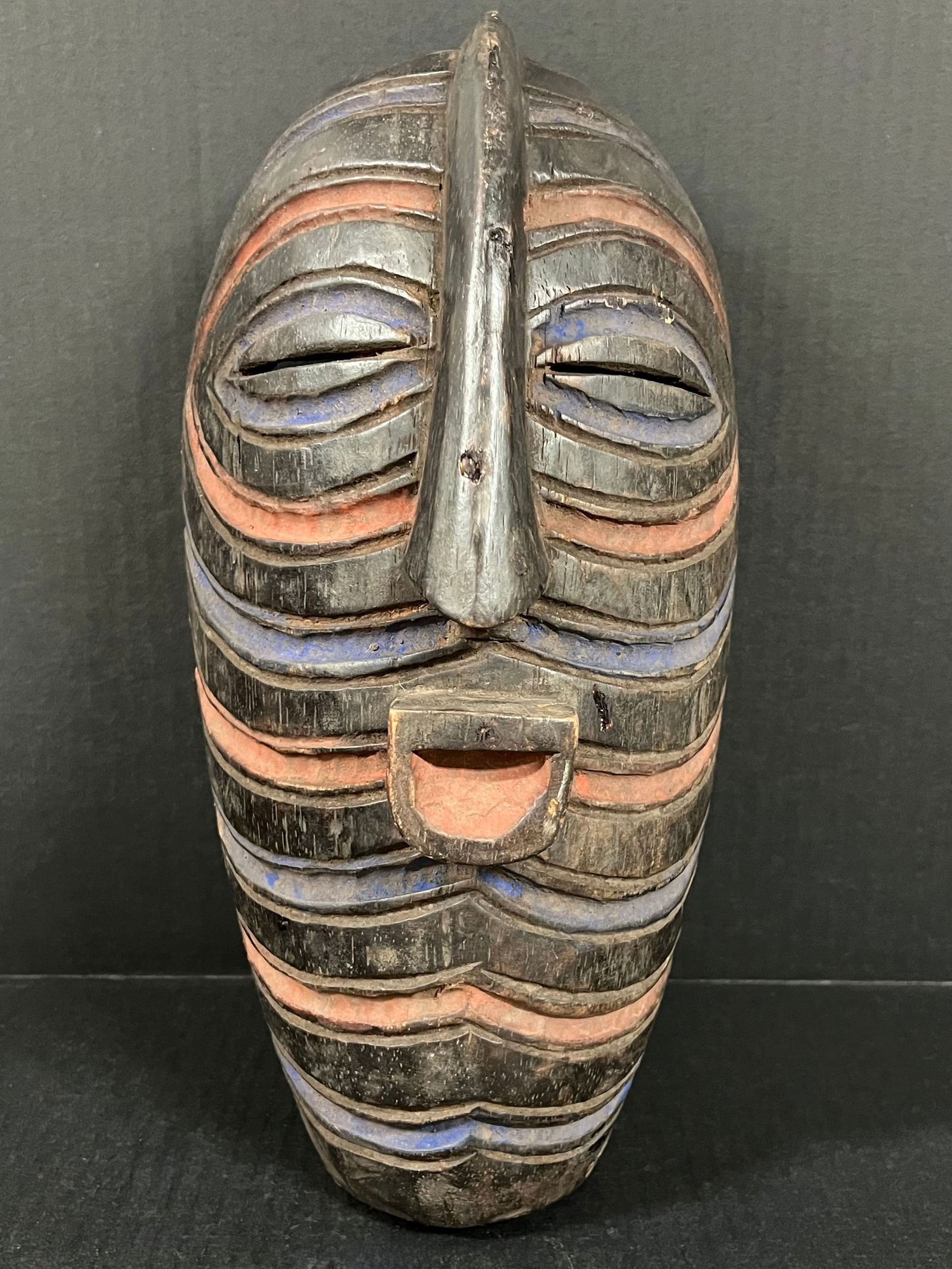 Songye Mask: African Tribal Art Songye Mask. The dimension is 15 inches high x 8 inches wide. Please be aware that some of the items are vintage, secondhand, old ages, antiques and may have a defects or sign of ag