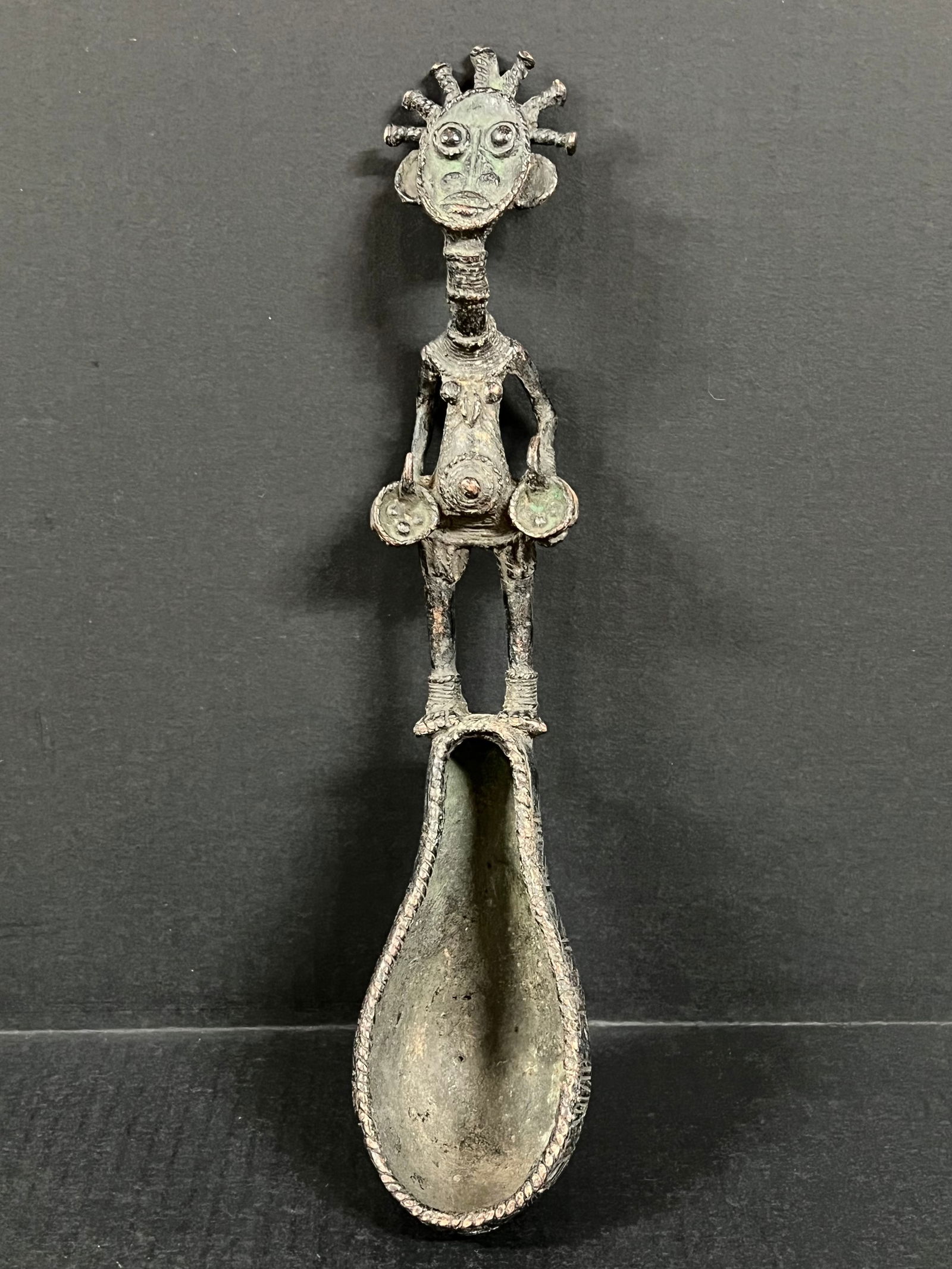 Dogon Bronze Spoon: African Tribal Art Dogon Bronze Spoon. The dimension is 14 inches high x 3 inches wide. Please be aware that some of the items are vintage, secondhand, old ages, antiques and may have a defects or