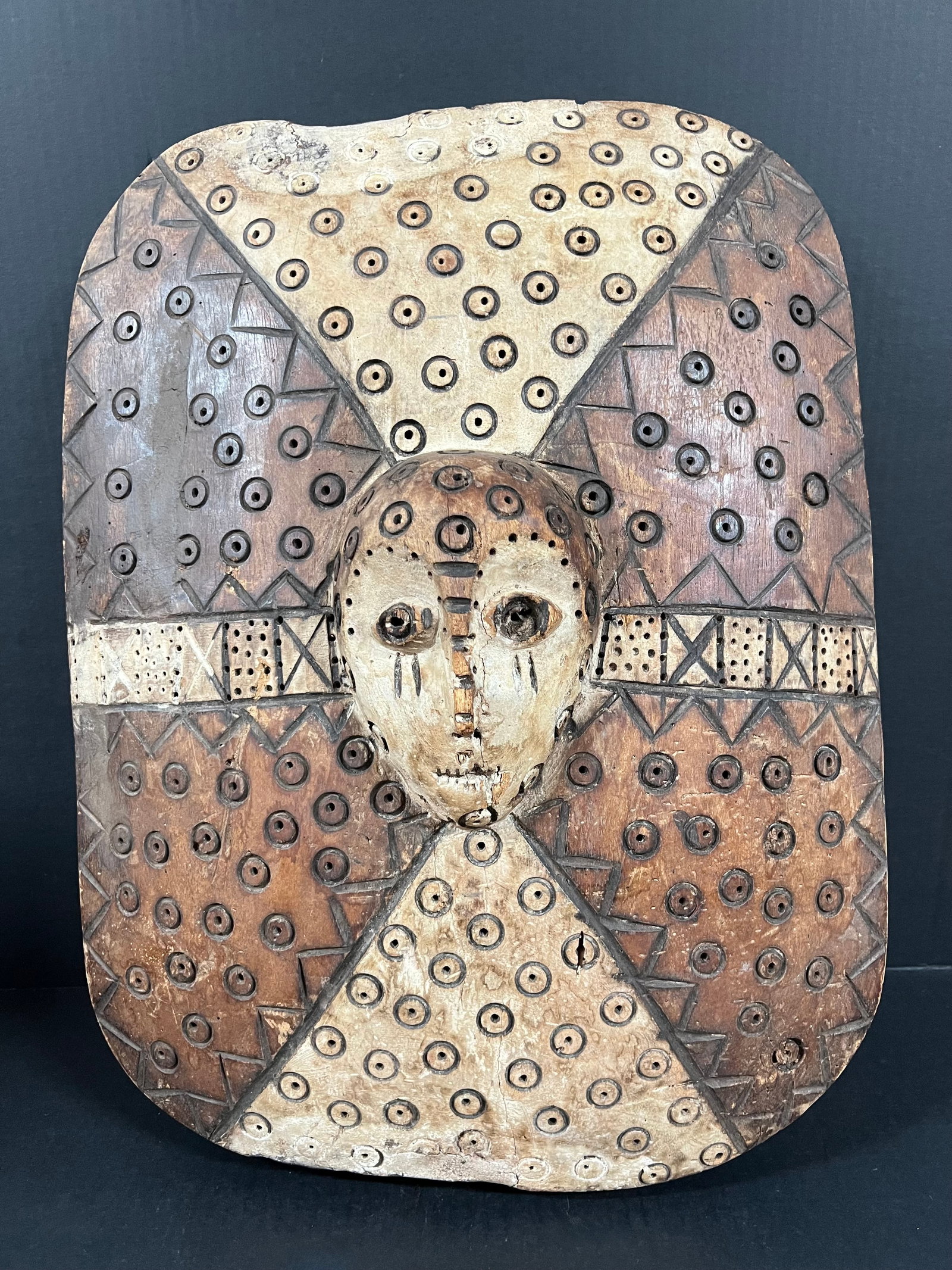 Lega Shield: African Tribal Art Lega Shield. The dimension is 21 inches high x 5 inches depth x 16 inches wide. Please be aware that some of the items are vintage, secondhand, old ages, antiques and may have a def