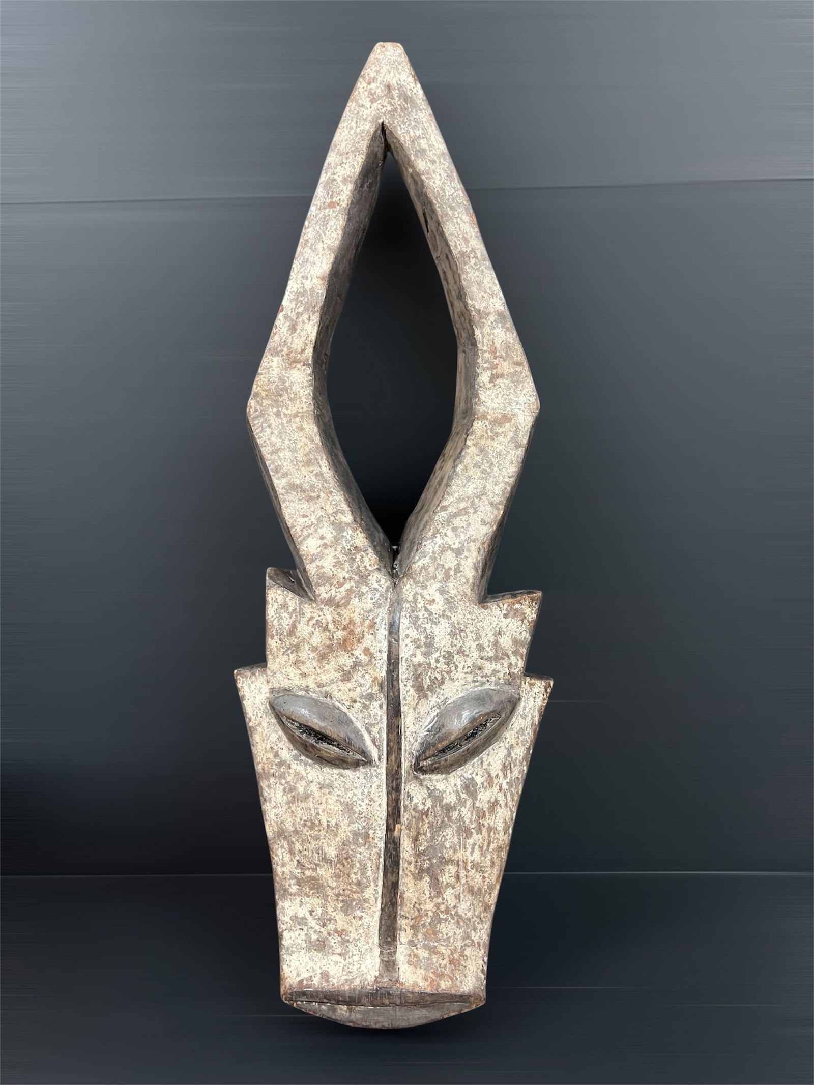 Large Kwele Mask: African Tribal Art Kwele Mask. The dimension is 29 inches high x 10 inches wide. Please be aware that some of the items are vintage, secondhand, old ages, antiques and may have a defects or sign of