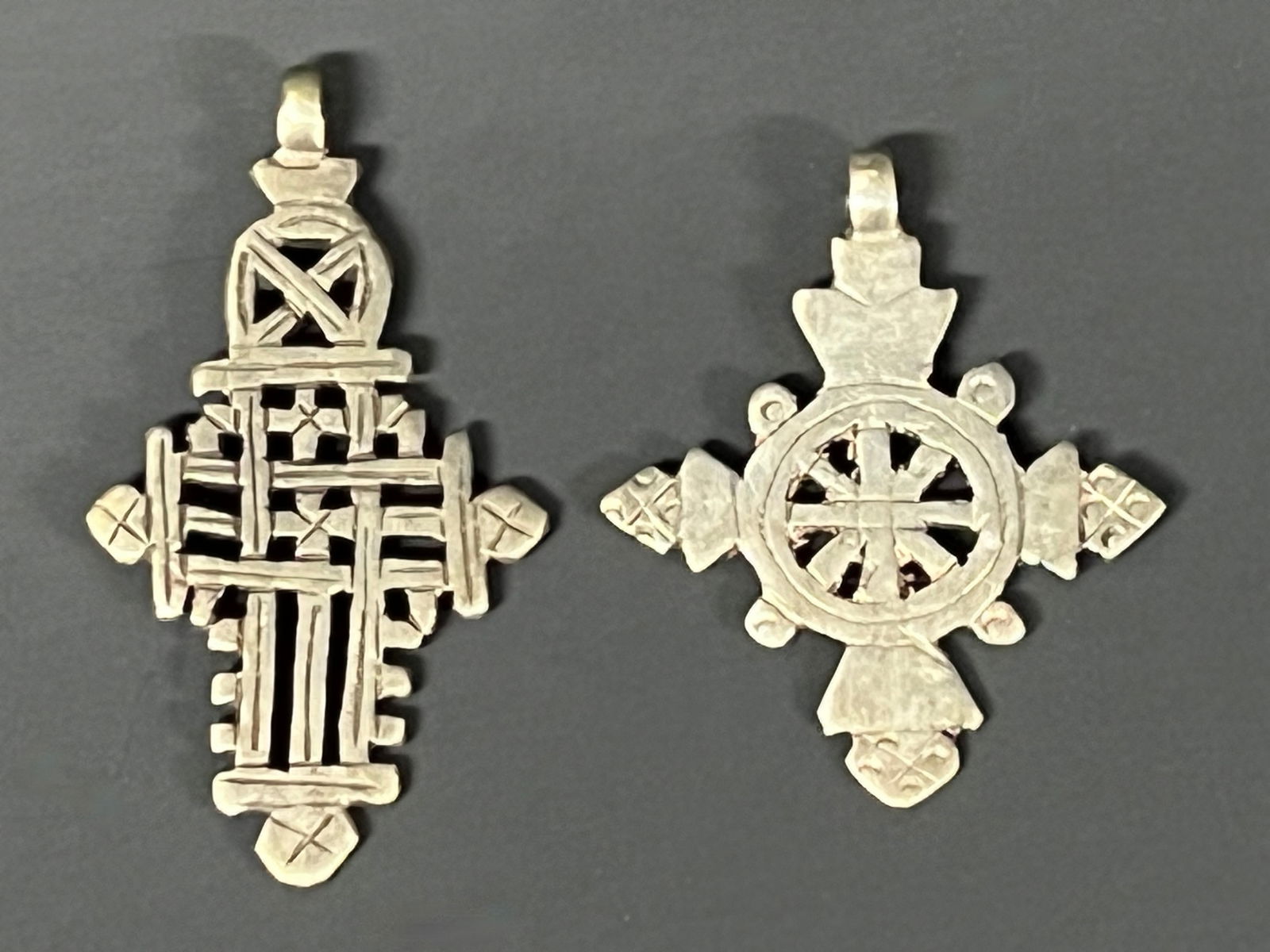 Ethiopian Metal Coptic Cross Pendant 2 pieces: African Tribal Art Ethiopian Metal Coptic Cross Pendant. The dimension is 3 inches high x 2.75 inches wide and 2.5 inches high x 2.25 inches wide. Please be aware that some of the items are vintage,