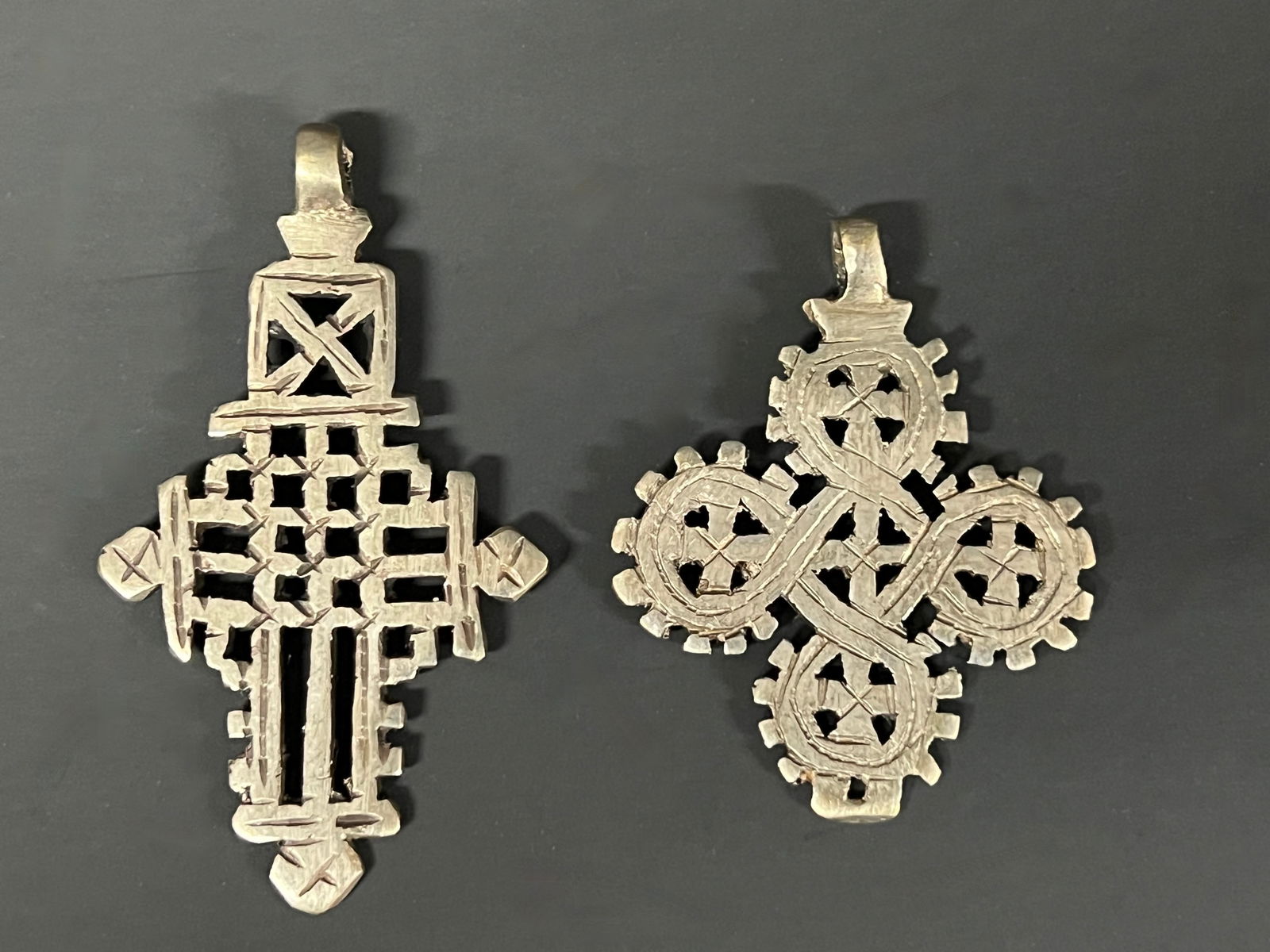 Ethiopian Metal Coptic Cross Pendant: African Tribal Art Ethiopian Metal Coptic Cross Pendant. The dimension is 3 inches high x 2.75 inches wide and 2.25 inches high x 1.75 inches wide. Please be aware that some of the items are vintage,