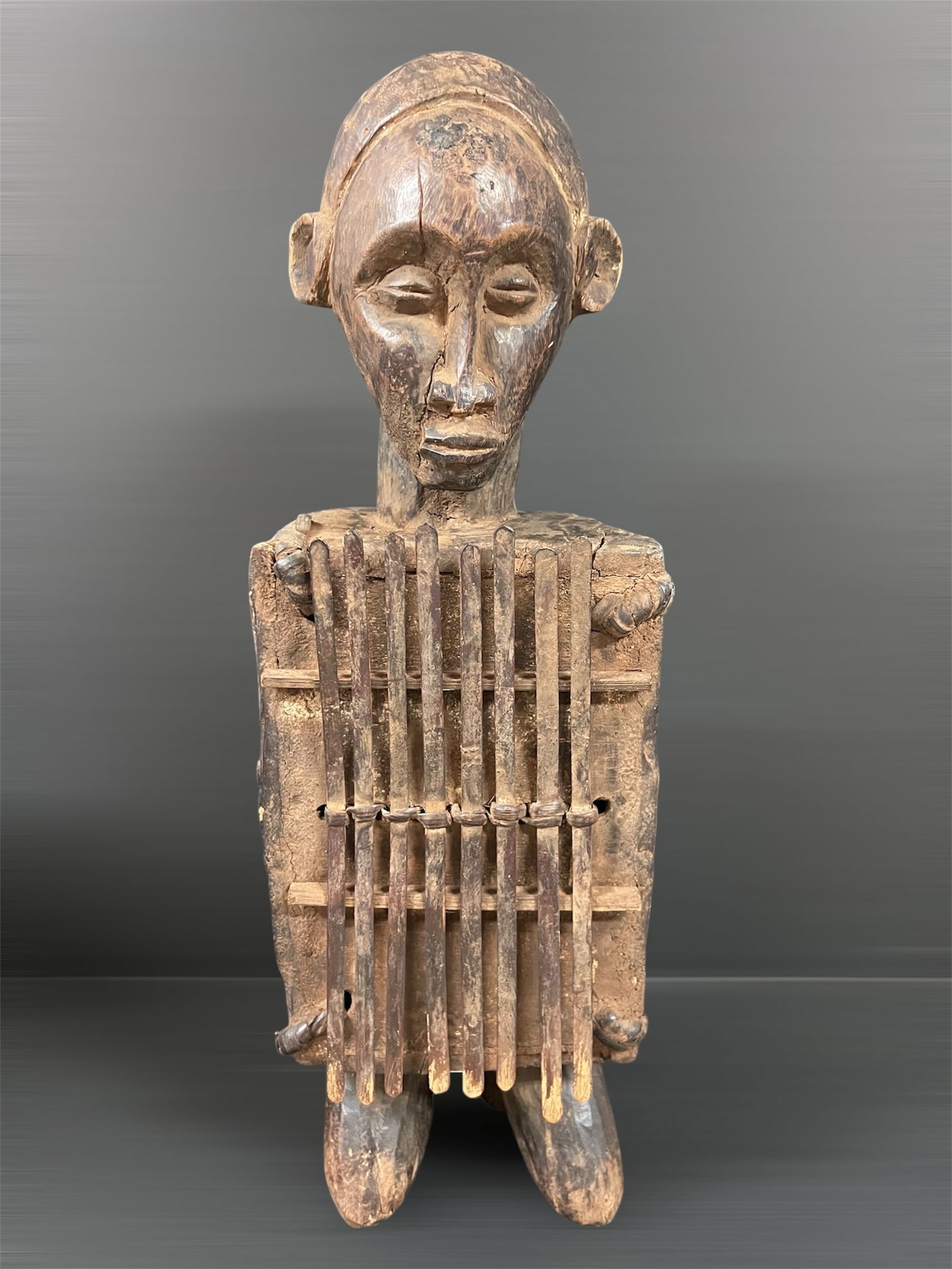 Fang Finger Piano Instrument: African Tribal Art Fang Finger Piano Instrument. The dimension is 21 inches high x 4 inches depth x 7 inches wide. Please be aware that some of the items are vintage, secondhand, old ages, antiques