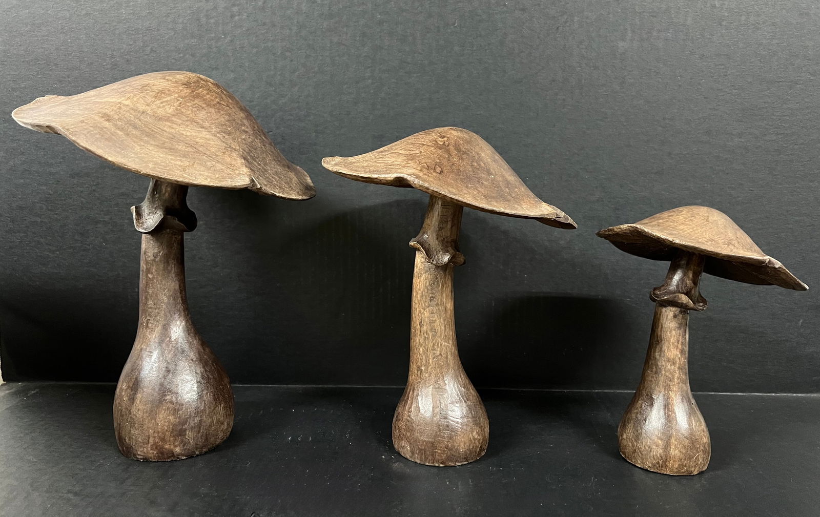 Set of Carved Wood Mushroom: Folk Art Carved Wood Set of Mushroom. The dimension is 8 inches high x 6 inches wide, 10 inches high x 8 inches wide and 12 inches high x 9 inches wide. Please be aware that some of the items are