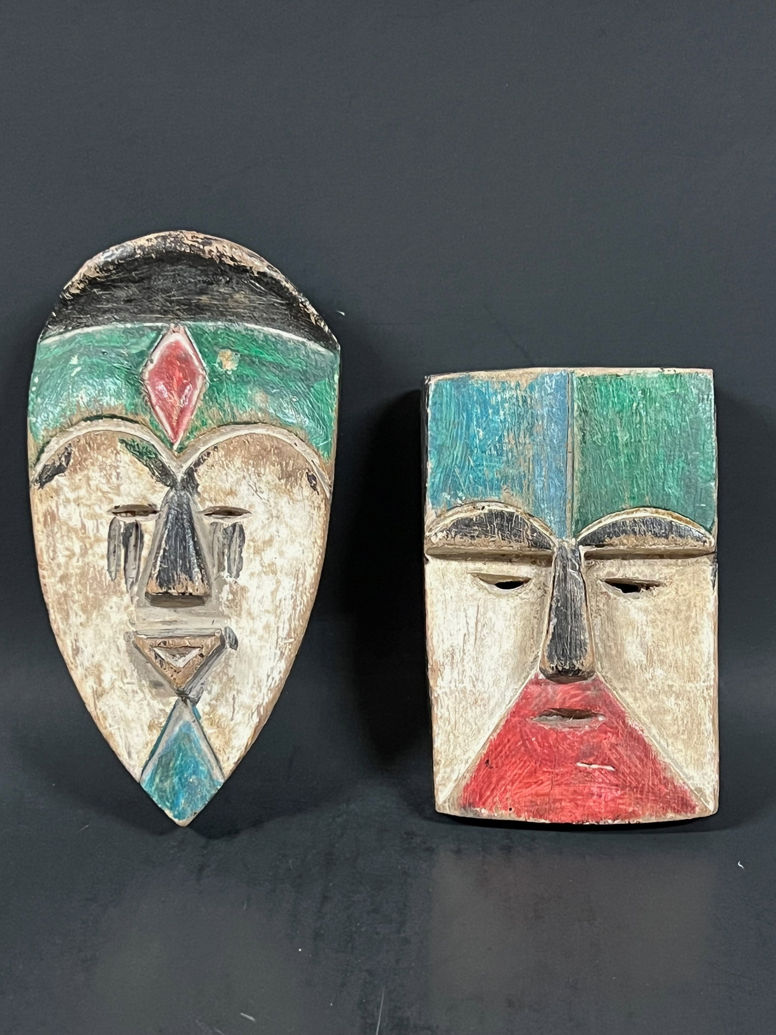 Passport Mask 2 pieces: African Tribal Art Passport Mask. The dimension is 5.75 inches high x 4 inches wide and 7.5 inches high x 3.75 inches wide. Please be aware that some of the items are vintage, secondhand, old ages,