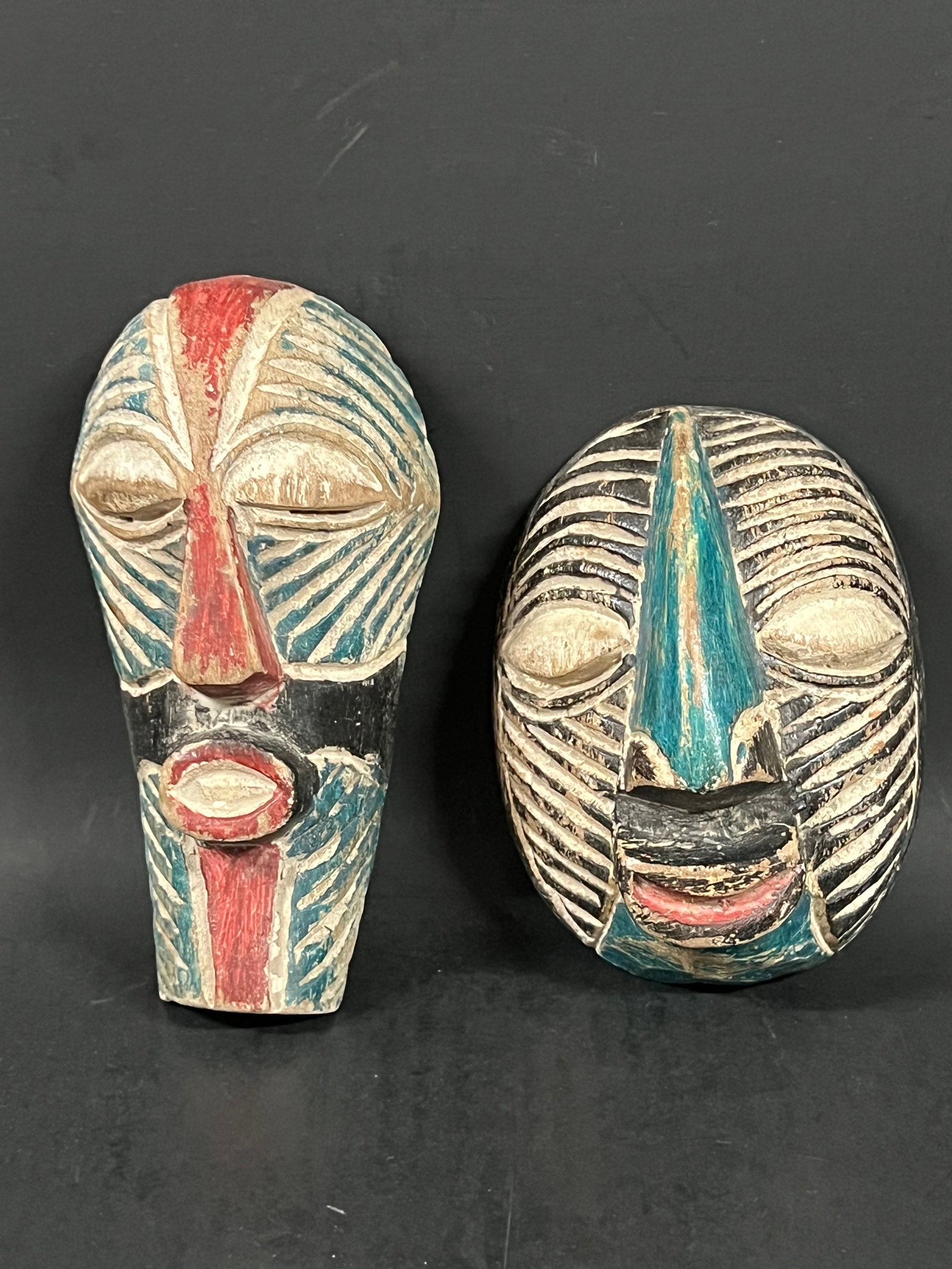 Passport Mask 2 pieces: African Tribal Art Passport Mask. The dimension is 5.75 inches high x 4 inches wide and 7.5 inches high x 3.75 inches wide. Please be aware that some of the items are vintage, secondhand, old ages,