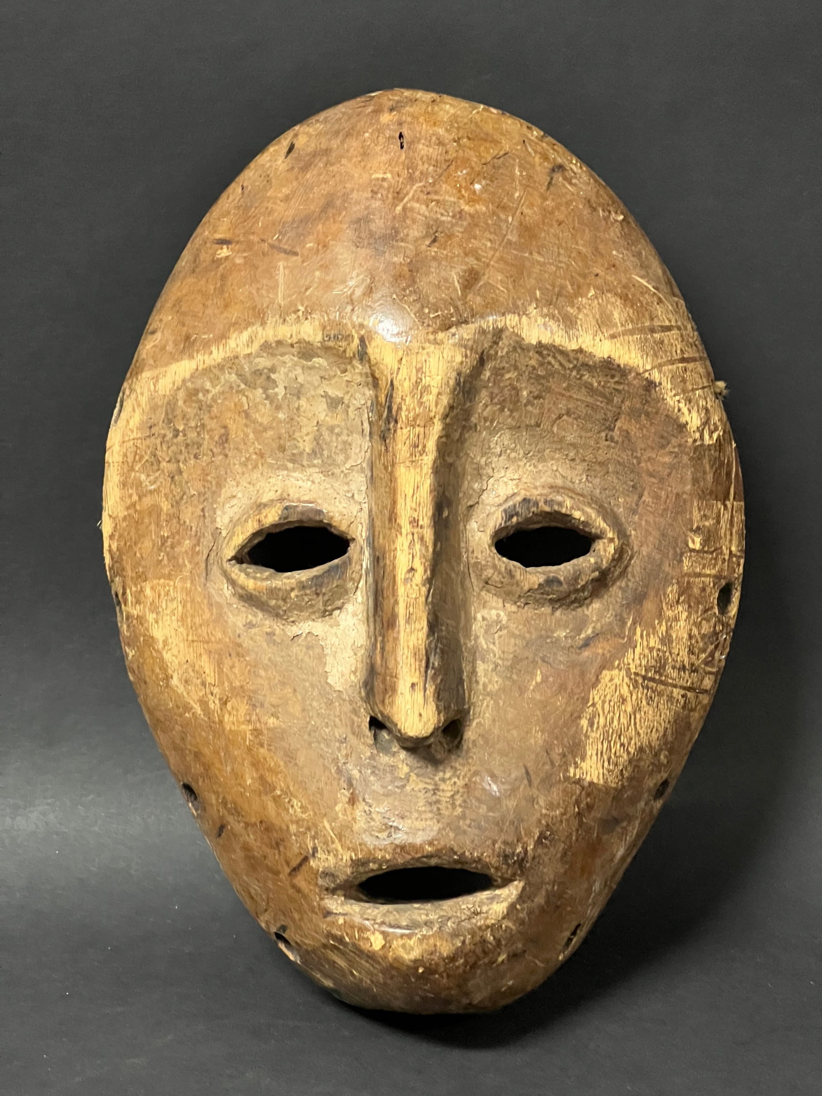 Lega Mask: African Tribal Art Lega Mask. The dimension is 9.5 inches high x 6.75 inches wide. Please be aware that some of the items are vintage, secondhand, old ages, antiques and may have a defects or sign of