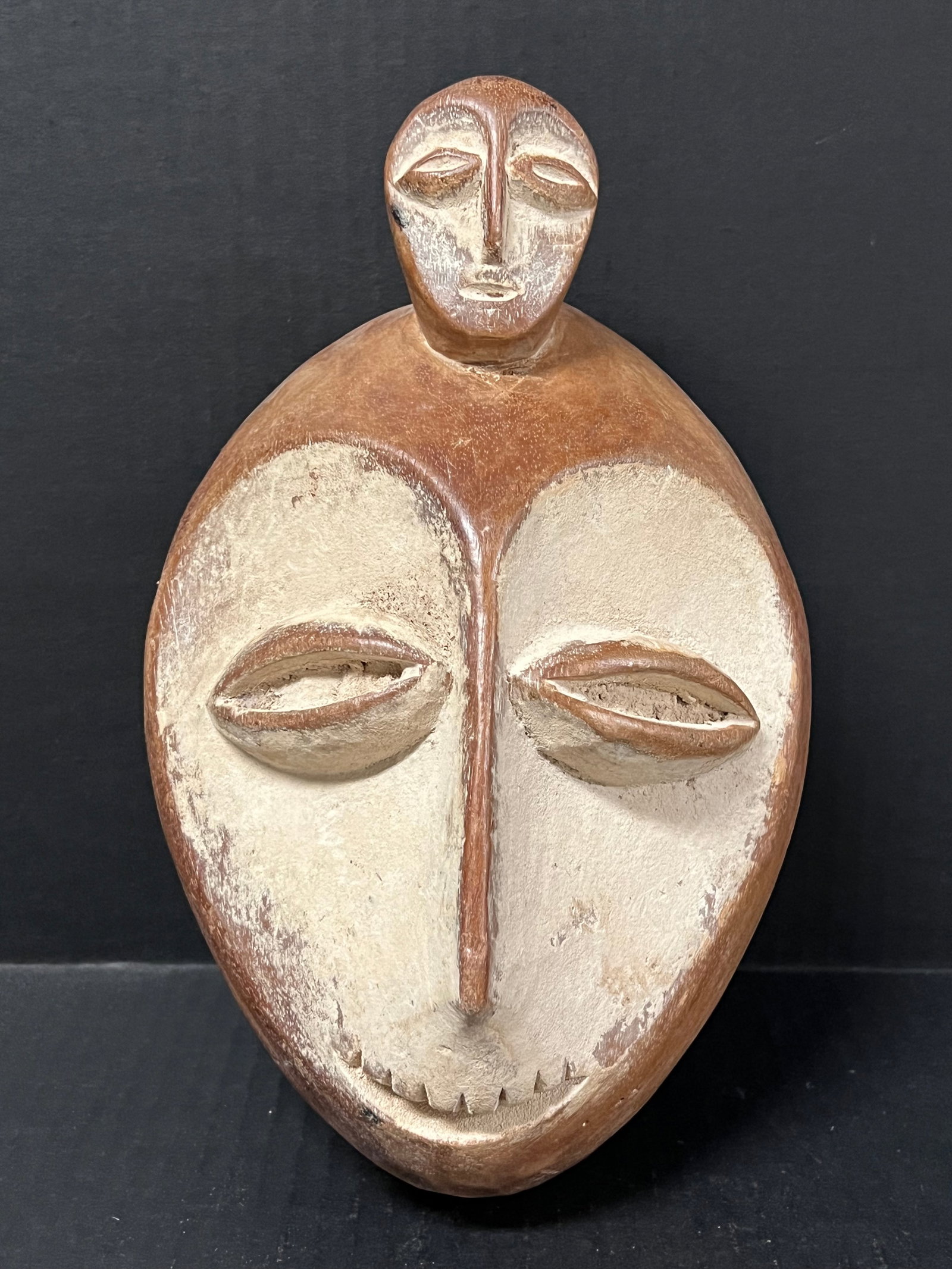 Lega Mask: African Tribal Art Lega Mask. The dimension is 10 inches high x 6.75 inches wide. Please be aware that some of the items are vintage, secondhand, old ages, antiques and may have a defects or sign of