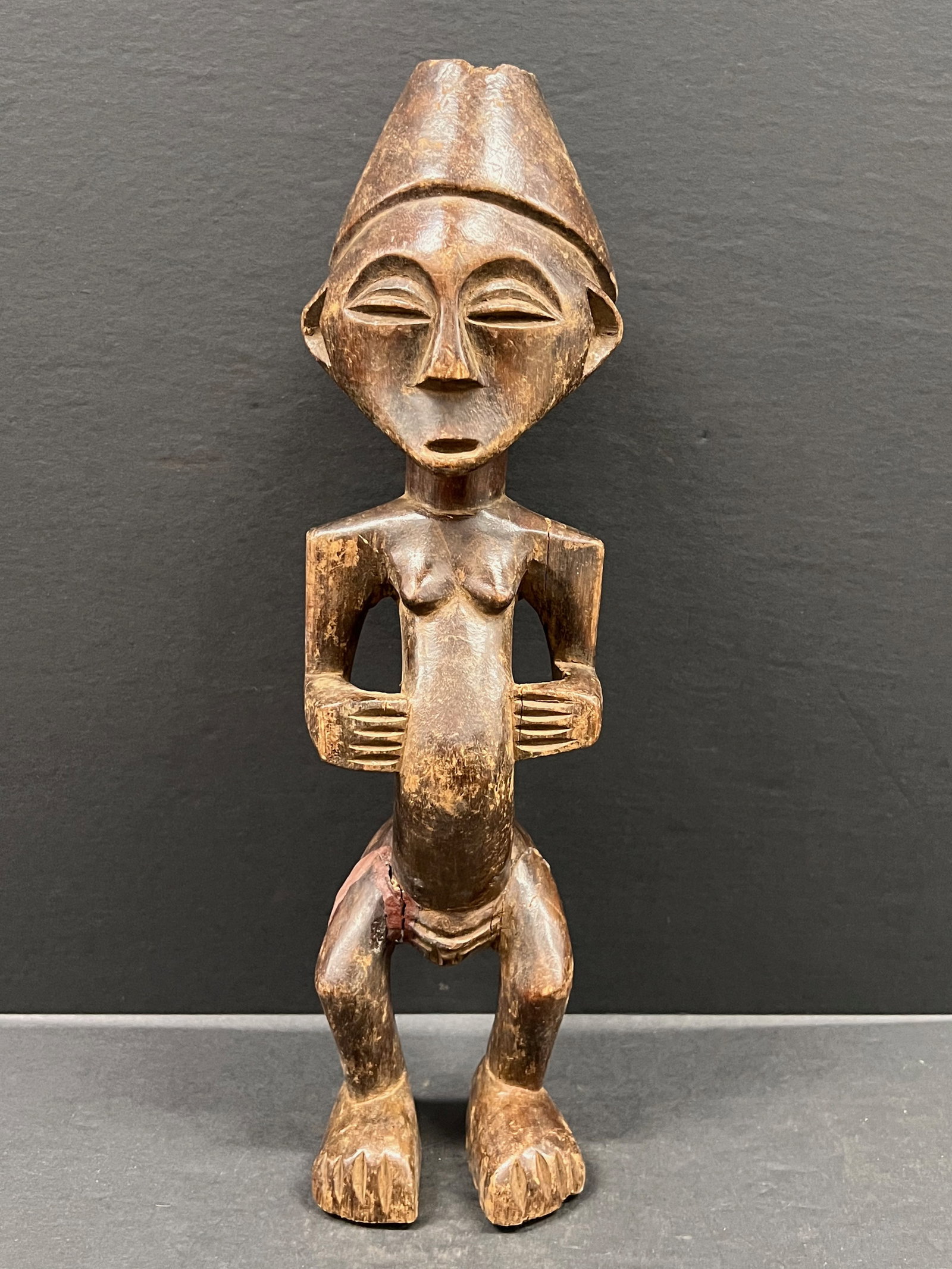 Kuba Statue: African Tribal Art Kuba Statue. The dimension is 15.5 inches high x 4.25 inches wide. Please be aware that some of the items are vintage, secondhand, old ages, antiques and may have a defects or sign 
