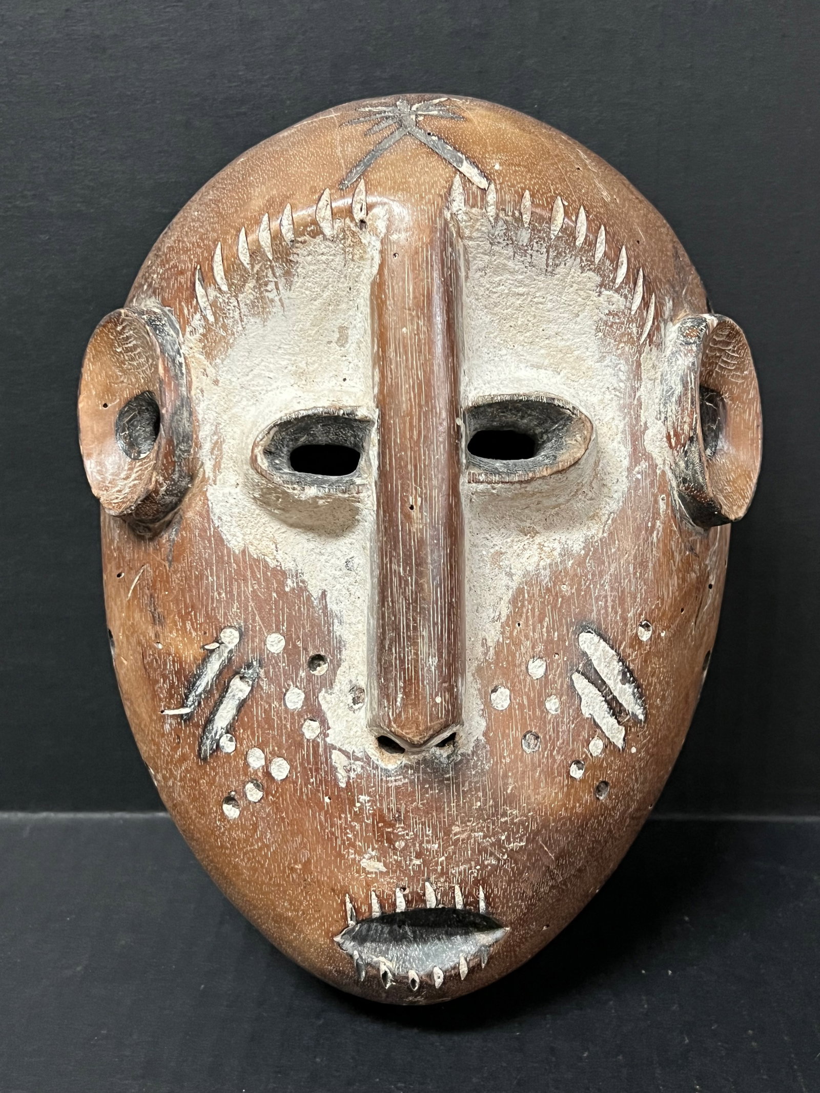 Lega Lukwakongo Mask: African Tribal Art Carved Wood Lega Lukwakongo Mask. The dimension is 9 inches high x 6.5 inches wide. Please be aware that some of the items are vintage, secondhand, old ages, antiques and may have