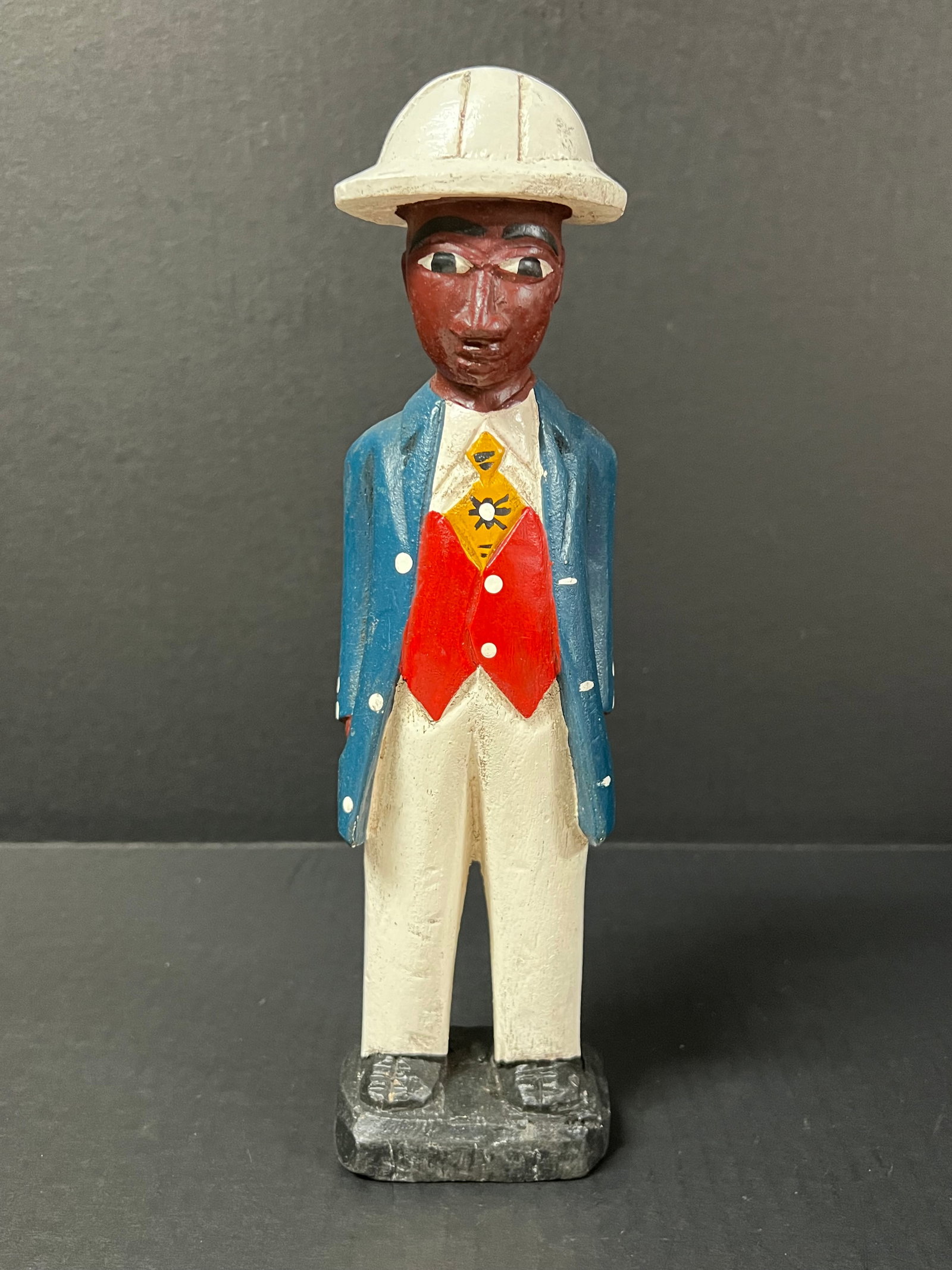 Colonial Statue: African Tribal Art Colonial Statue. The dimension is 11.5 inches high x 3 inches wide. Please be aware that some of the items are vintage, secondhand, old ages, antiques and may have a defects or
