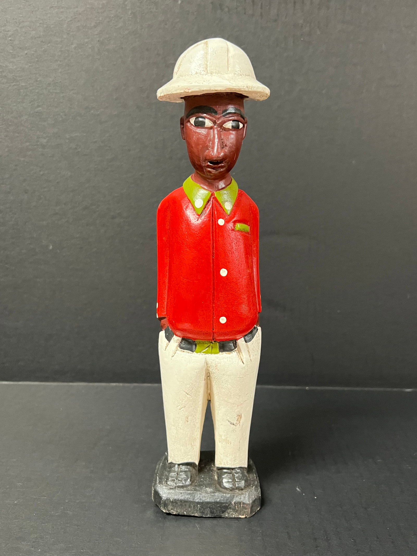 Colonial Statue: African Tribal Art Colonial Statue. The dimension is 12 inches high x 3 inches wide. Please be aware that some of the items are vintage, secondhand, old ages, antiques and may have a defects or sign