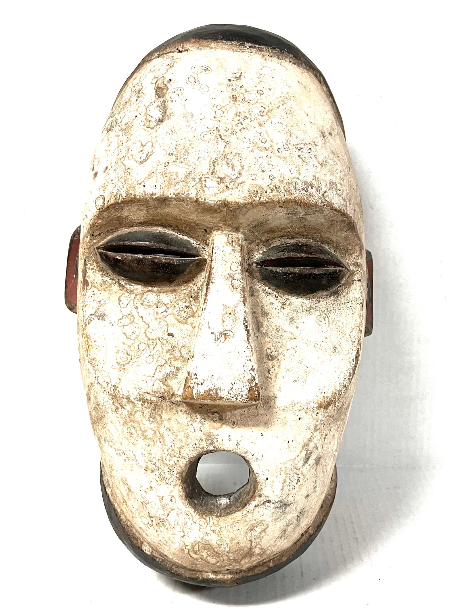 Kumu Mask: African Tribal Art Kumu Mask. The dimension is 16 inches high x 9.5 inches wide. Please be aware that some of the items are vintage, secondhand, old ages, antiques and may have a defects or sign of