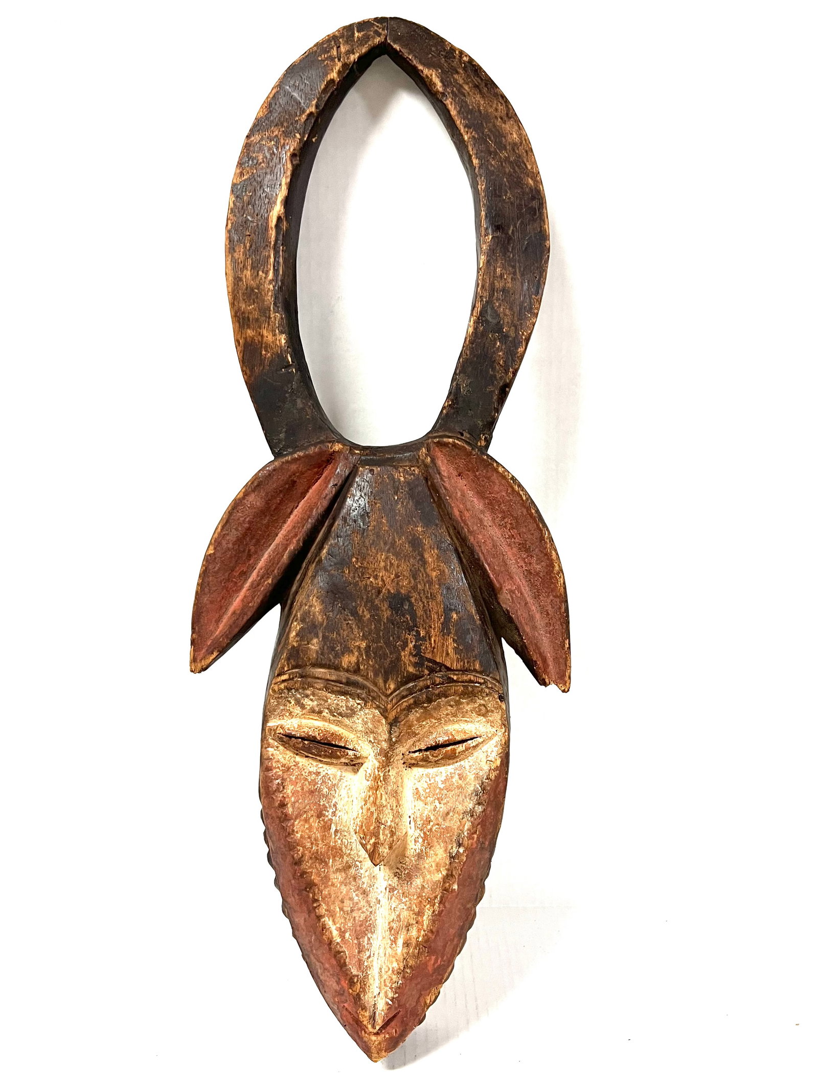Kwele Mask: African Tribal Art Kwele Mask. The dimension is 24.5 inches high x 9 inches wide. Please be aware that some of the items are vintage, secondhand, old ages, antiques and may have a defects or sign of