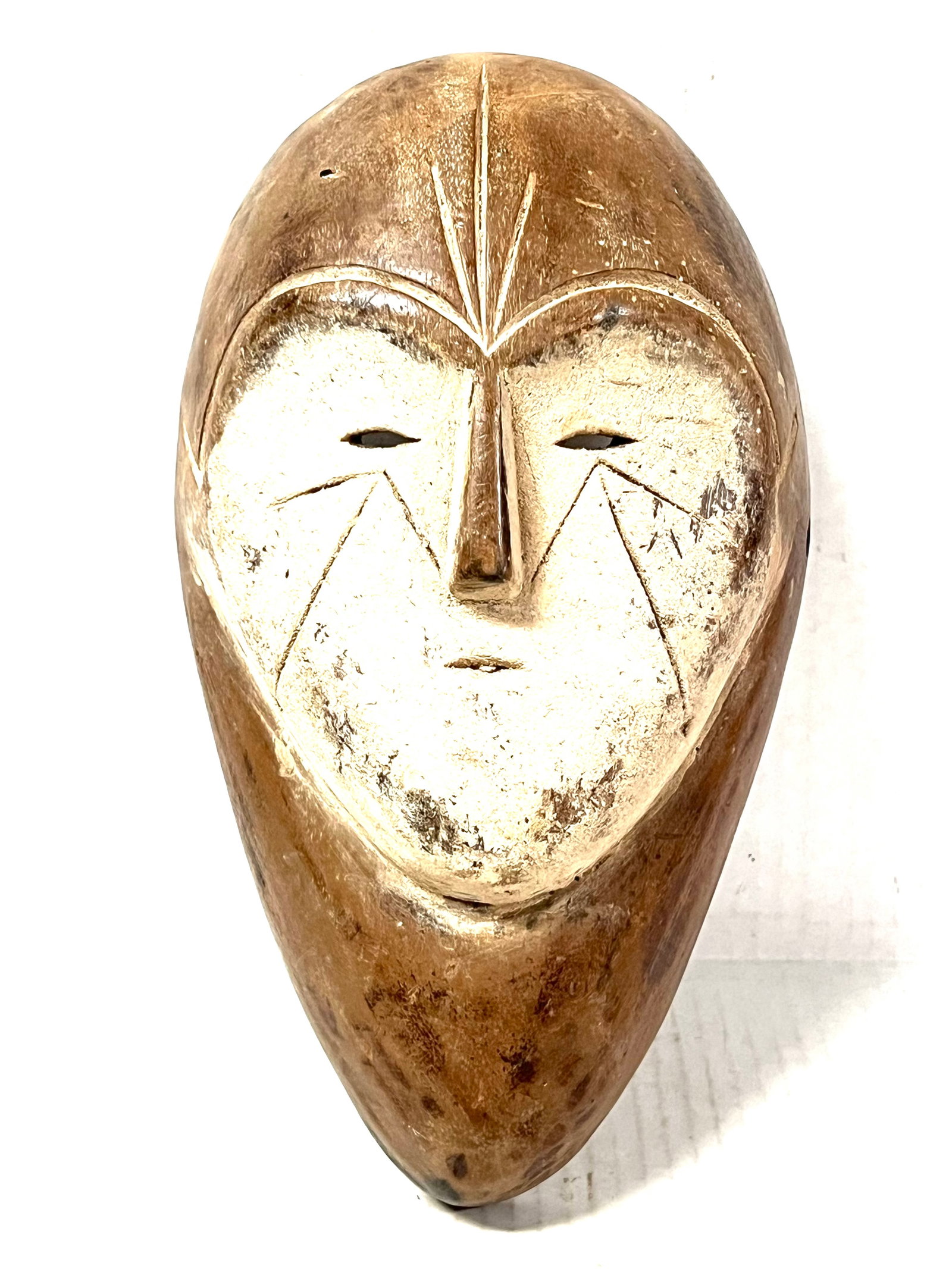 Lega Mask: African Tribal Art Lega Mask. The dimension is 10.5 inches high x 6 inches wide. Please be aware that some of the items are vintage, secondhand, old ages, antiques and may have a defects or sign of