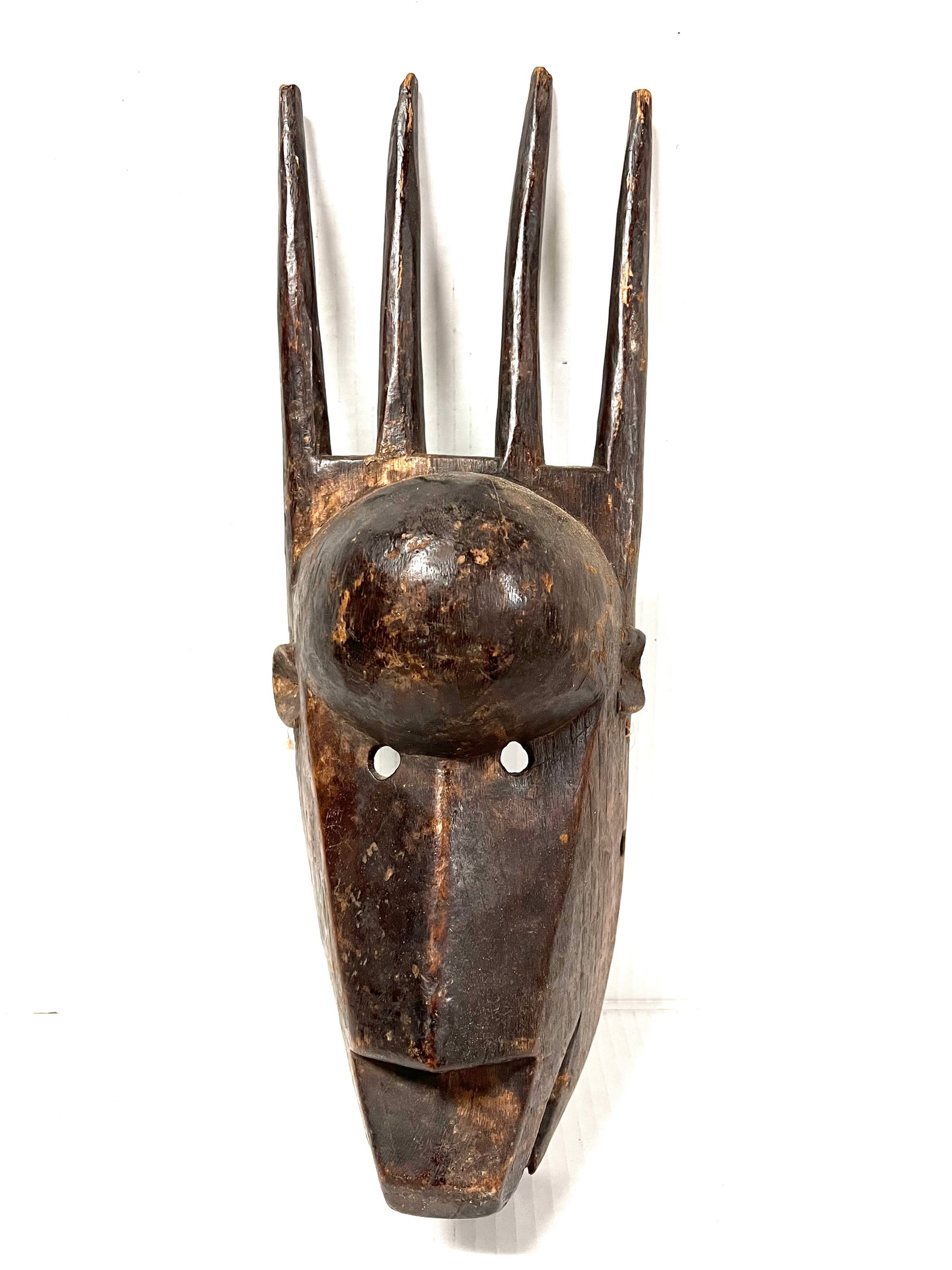 Bamana Mask: African Tribal Art Bamana Mask. The dimension is 19.5 inches high x 6.5 inches wide. Please be aware that some of the items are vintage, secondhand, old ages, antiques and may have a defects or sign