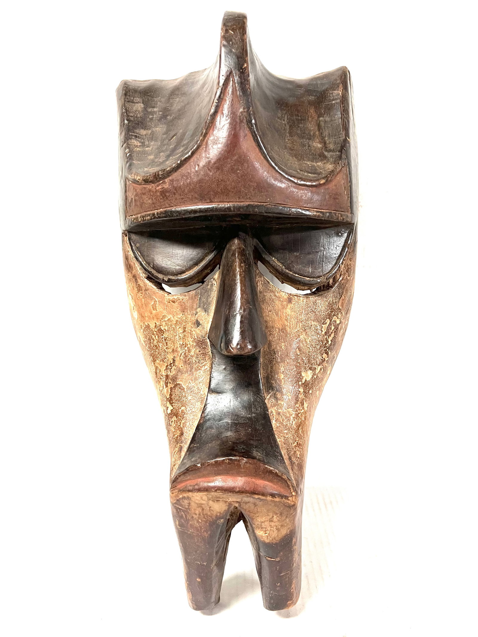 Kwele Mask: African Tribal Art Kwele Mask. The dimension is 17 inches high x 8.5 inches wide. Please be aware that some of the items are vintage, secondhand, old ages, antiques and may have a defects or sign of