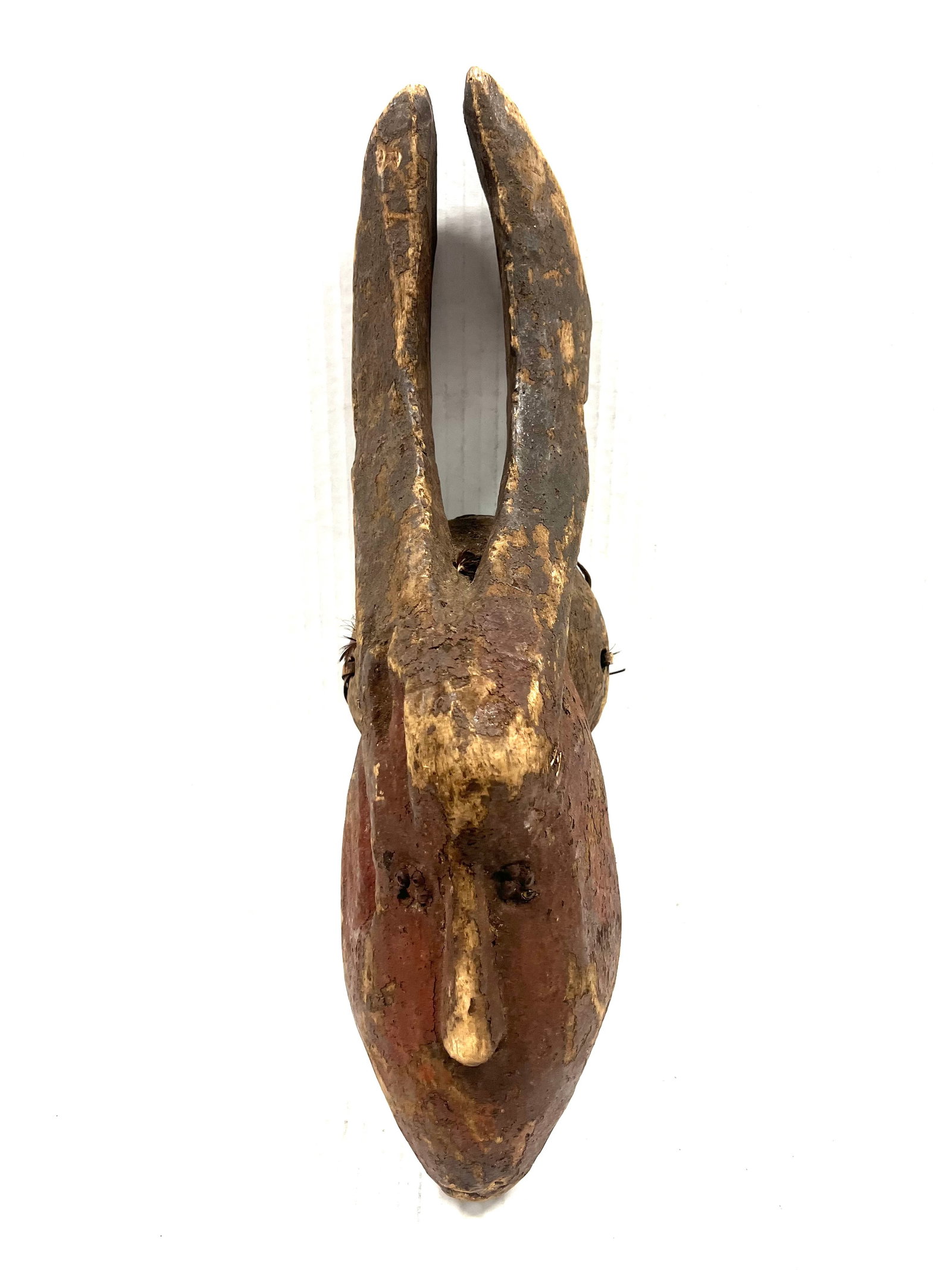 Mama Mask: African Tribal Art Mama Mask. The dimension is 18 inches high x 4.75 inches wide. Please be aware that some of the items are vintage, secondhand, old ages, antiques and may have a defects or sign of