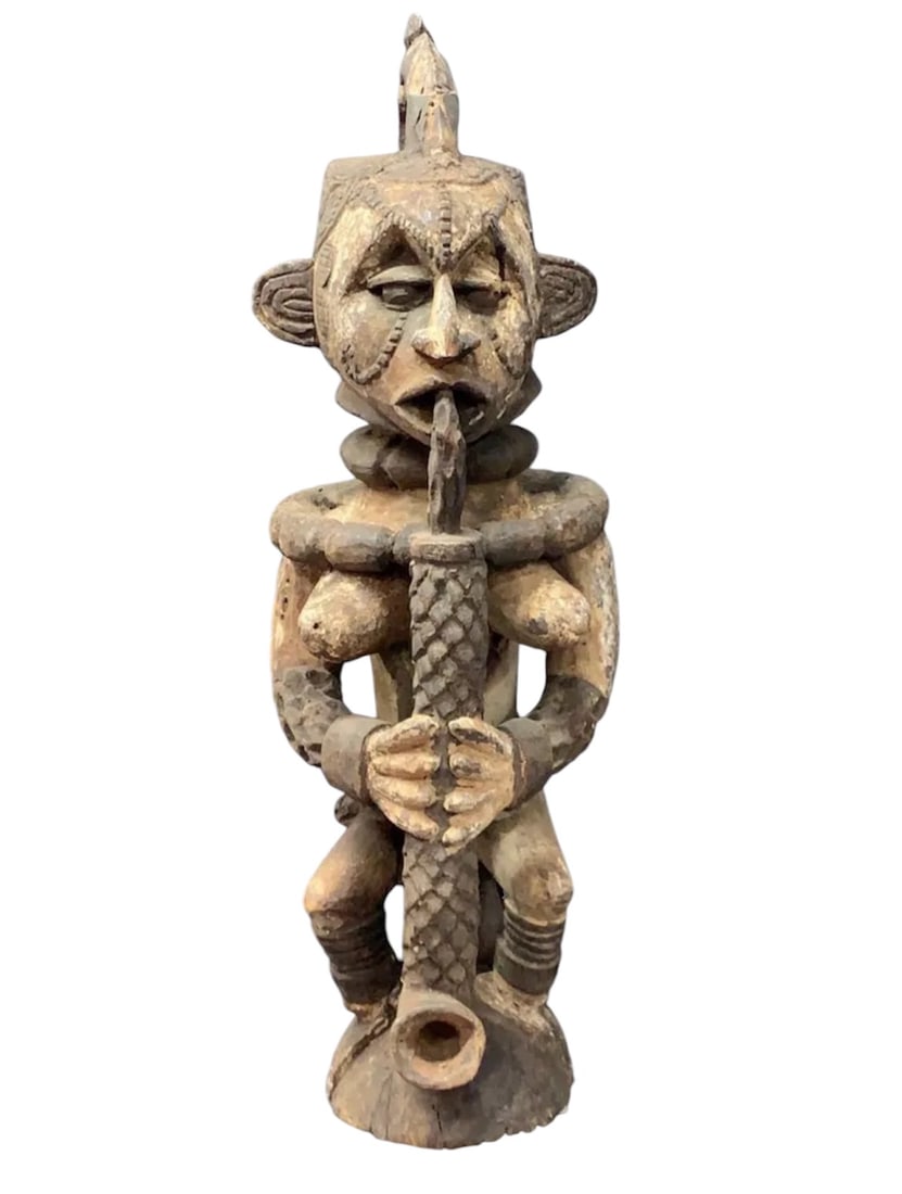 Idoma Statue: African Tribal Art Idoma Statue. The dimension is 26.5 inches high x 8 inches wide. Please be aware that some of the items are vintage, secondhand, old ages, antiques and may have a defects or sign
