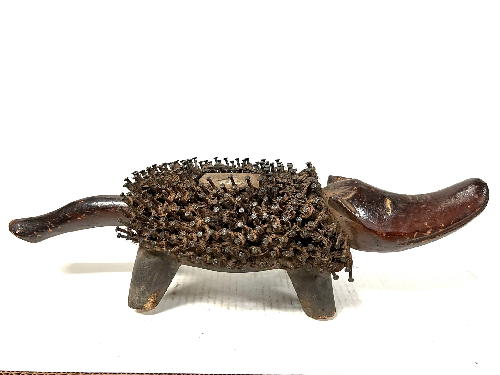 Dog Fetish Statue: African Tribal Art Dog Fetish Statue. The dimension is 5 inches high x 16.5 inches wide. Please be aware that some of the items are vintage, secondhand, old ages, antiques and may have a defects or