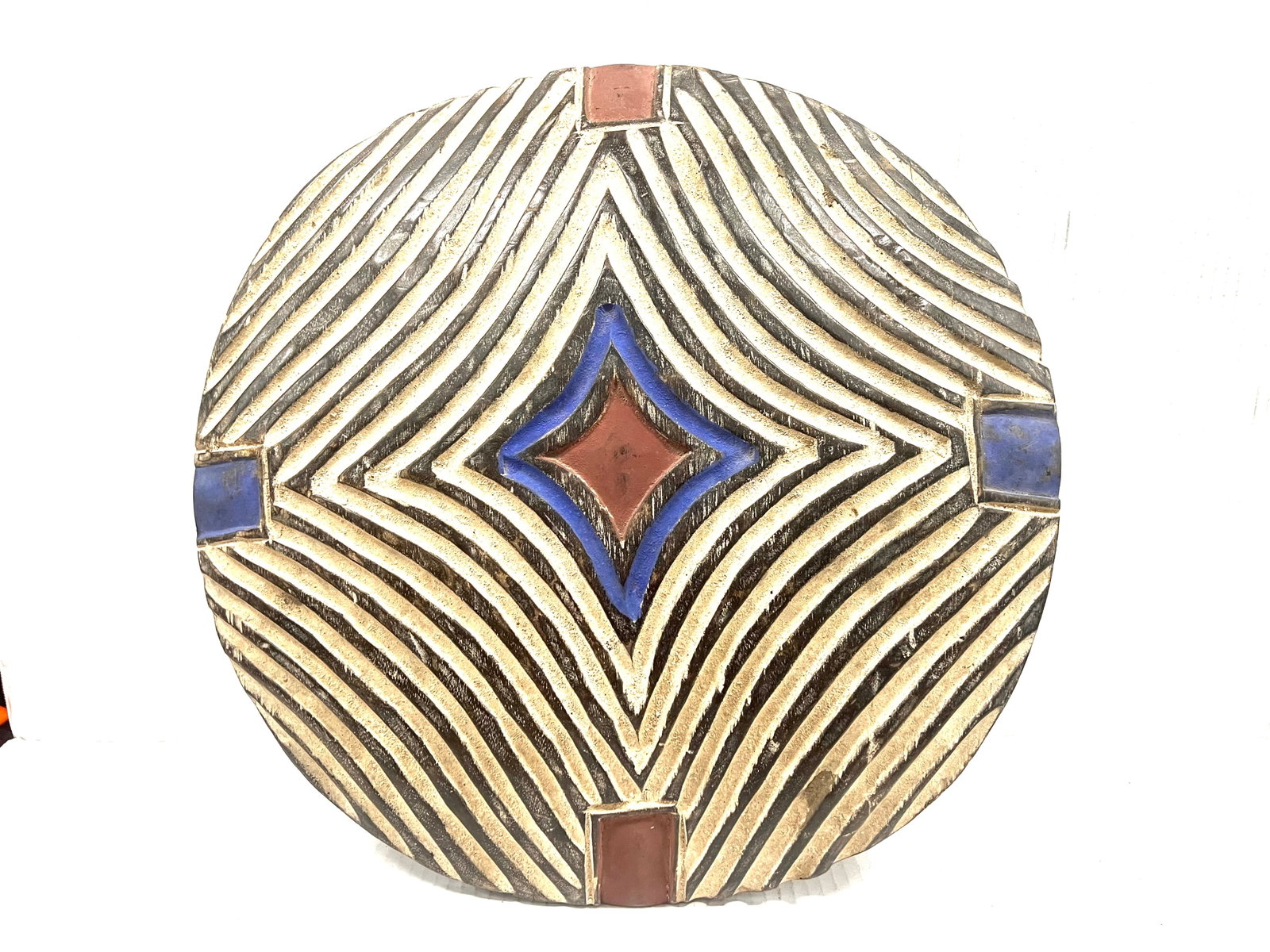 Zulu Shield: African Tribal Art Zulu Shield. The dimension is 19 inches high x 19 inches wide. Please be aware that some of the items are vintage, secondhand, old ages, antiques and may have a defects or sign of