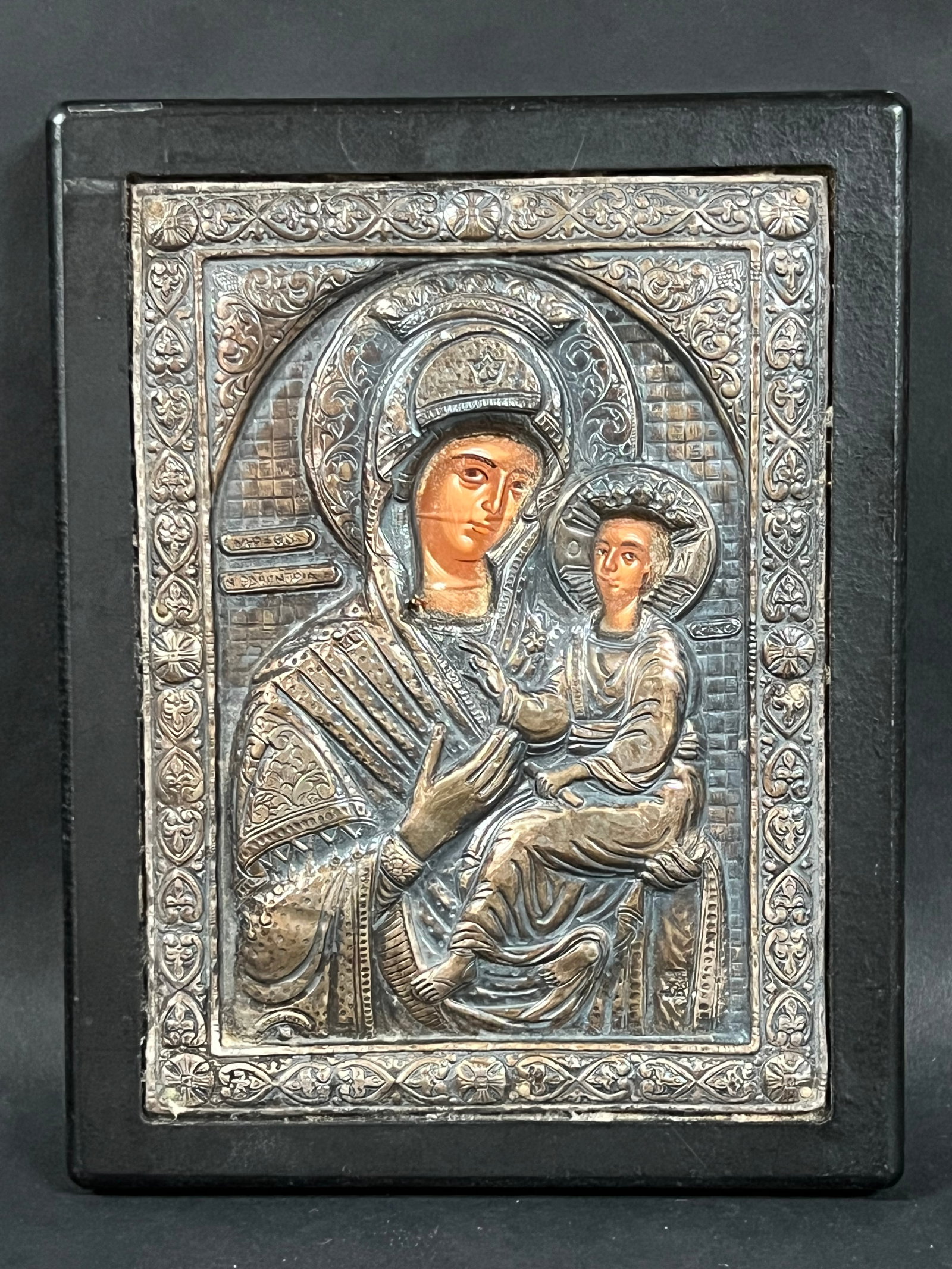 Icon with Silver in Wood Plaque: Religious Art Icon with Silver in Wood Plaque. The dimension is 9.5 inches high x 7.25 inches wide. Please be aware that some of the items are vintage, secondhand, old ages, antiques and may have a de