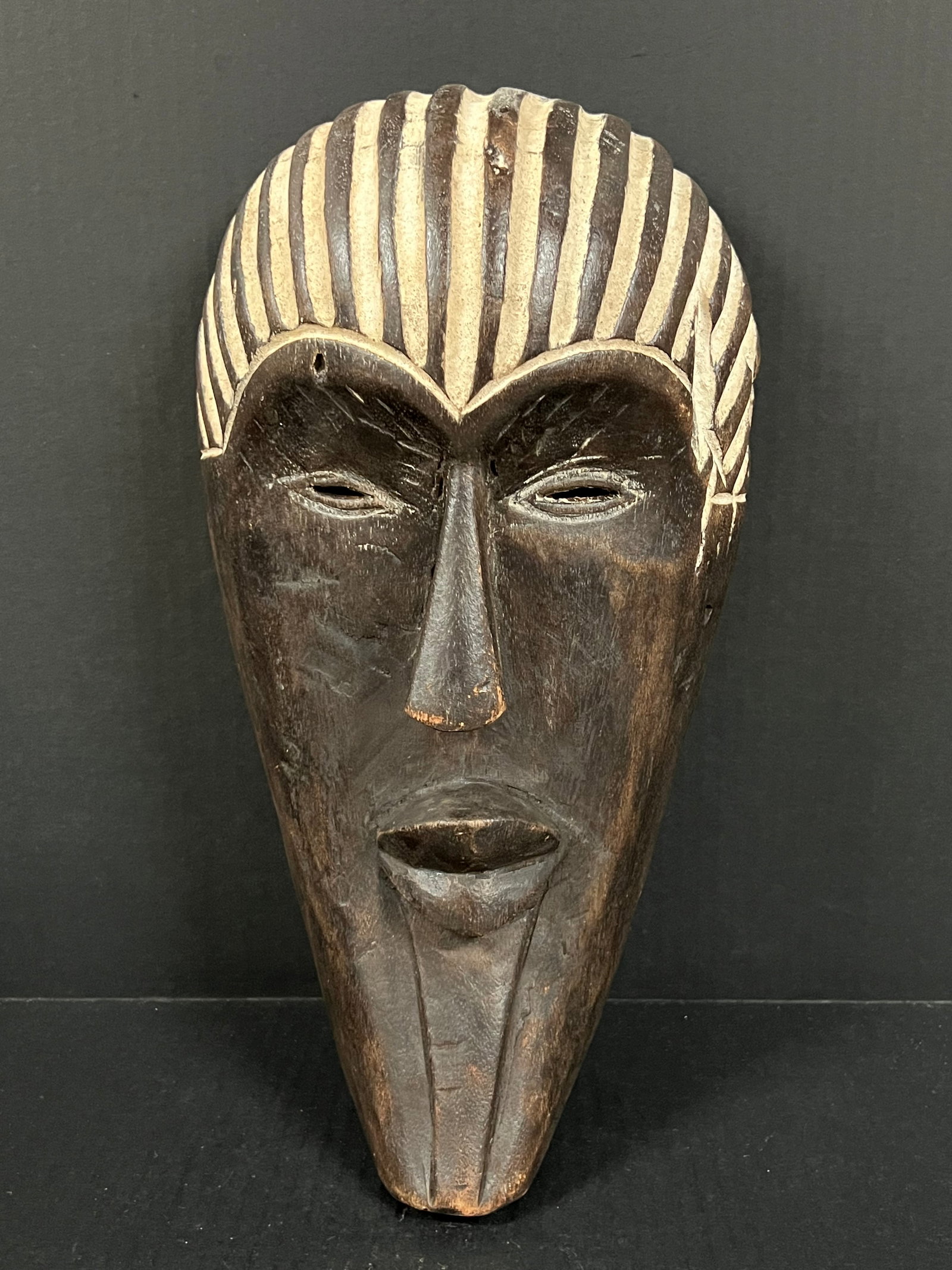 Songye Mask: African Tribal Art Songye Mask. The dimension is 13.5 inches high x 13.5 inches wide. Please be aware that some of the items are vintage, secondhand, old ages, antiques and may have a defects or sign