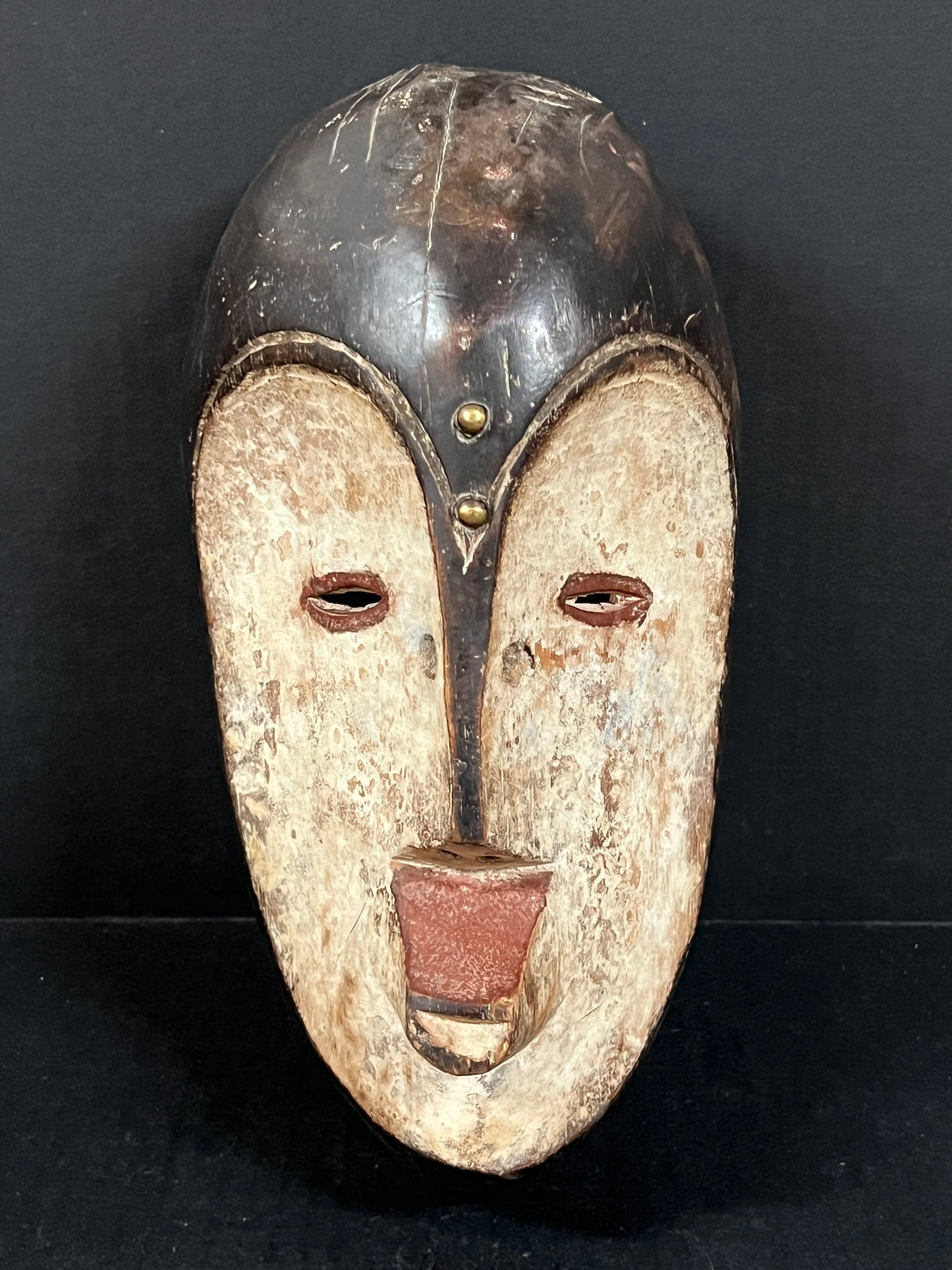 Fang Mask: African Tribal Art Fang Mask. The dimension is 12 inches high x 6.25 inches wide. Please be aware that some of the items are vintage, secondhand, old ages, antiques and may have a defects or sign of