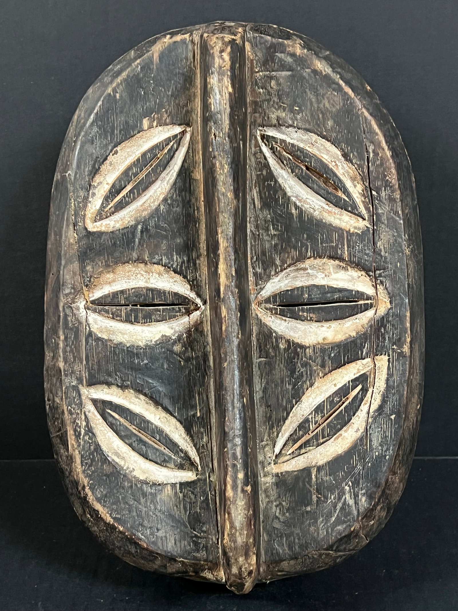Kwele Mask: African Tribal Art Kwele Mask. The dimension is 13 inches high x 8.75 inches wide. Please be aware that some of the items are vintage, secondhand, old ages, antiques and may have a defects or sign of