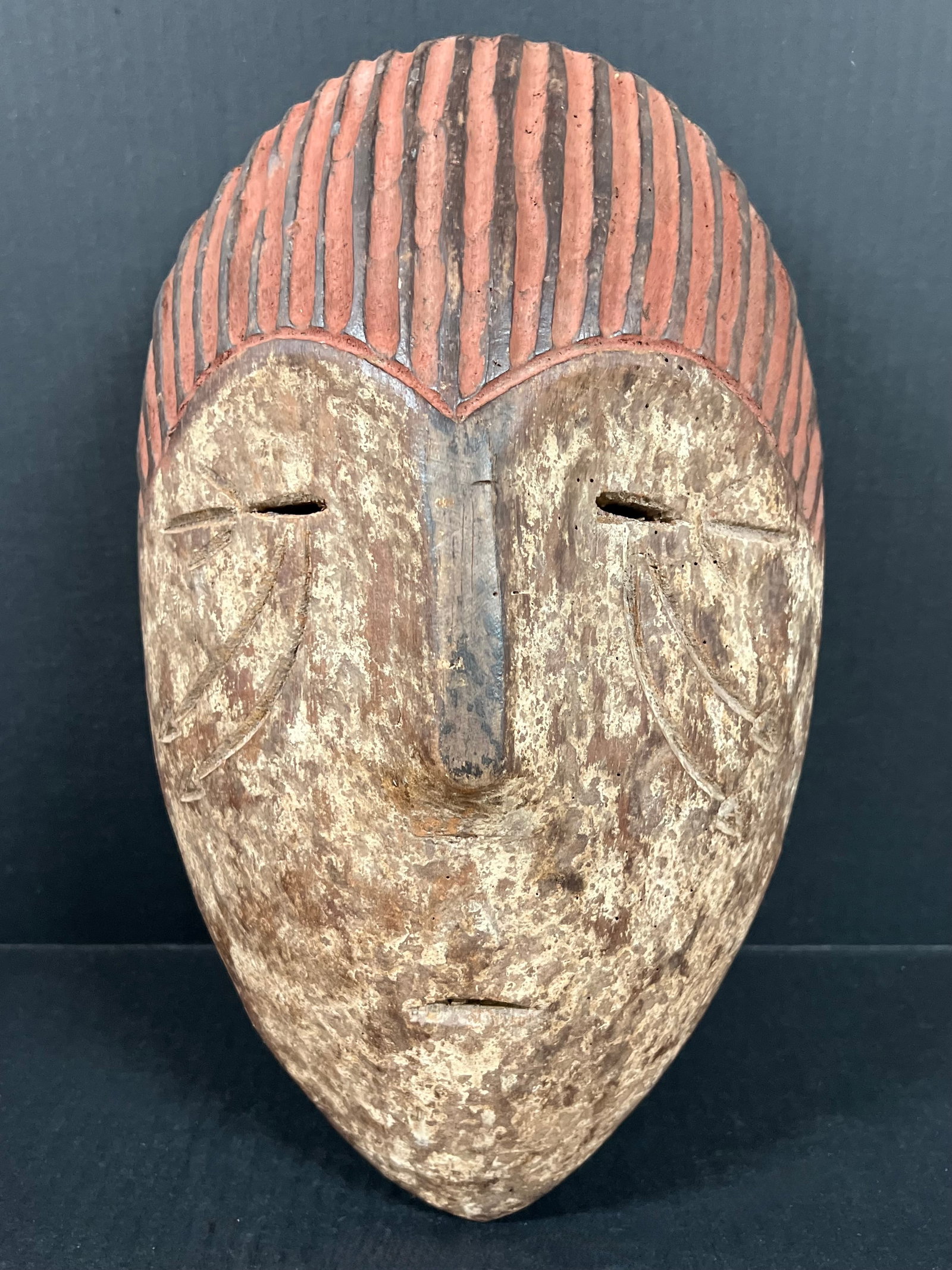 Aduma Mask: African Tribal Art Aduma Mask. The dimension is 15.5 inches high x 9.5 inches wide. Please be aware that some of the items are vintage, secondhand, old ages, antiques and may have a defects or sign of