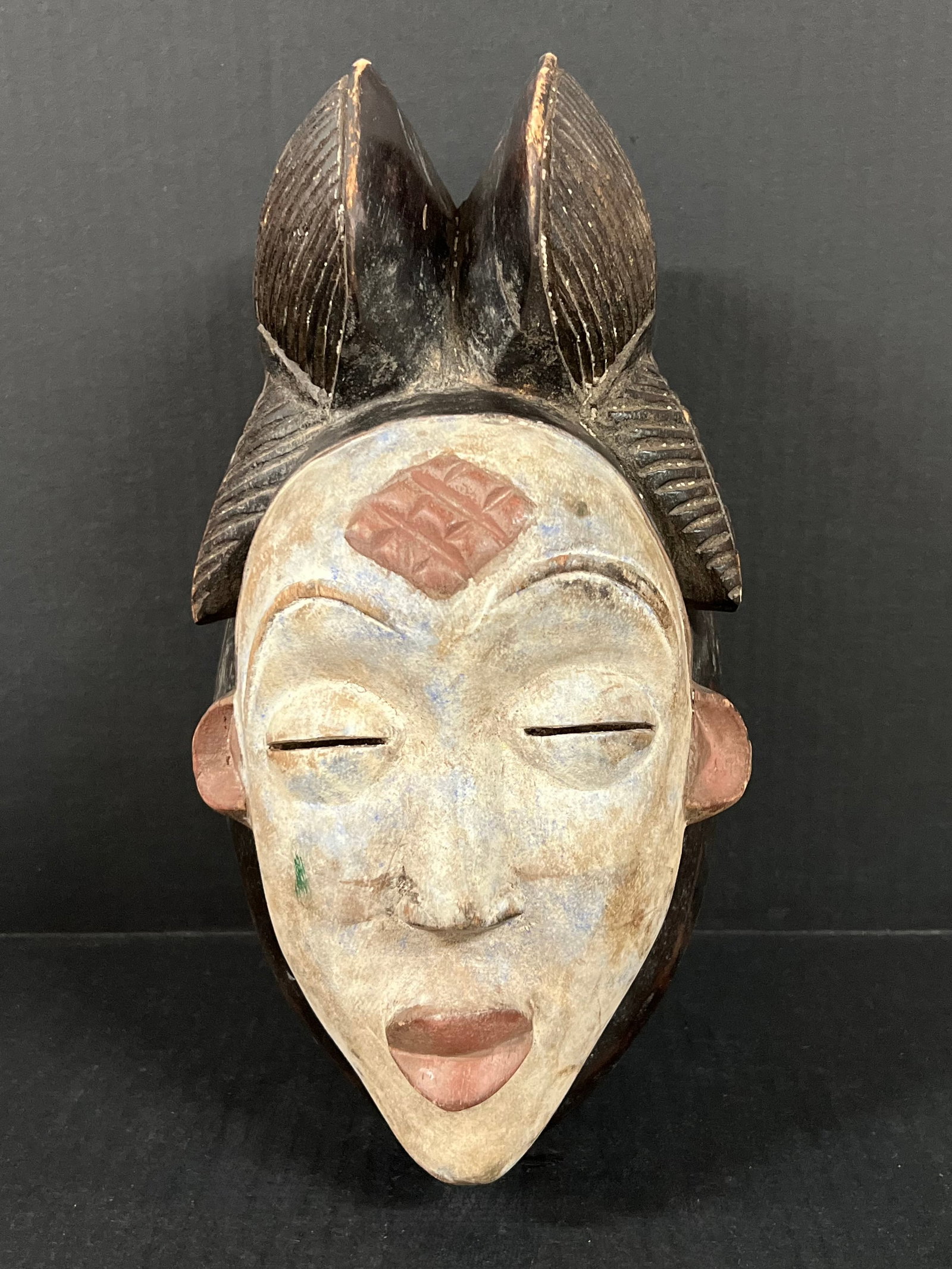 Punu Mask: African Tribal Art Punu Mask. The dimension is 13 inches high x 7 inches wide. Please be aware that some of the items are vintage, secondhand, old ages, antiques and may have a defects or sign of