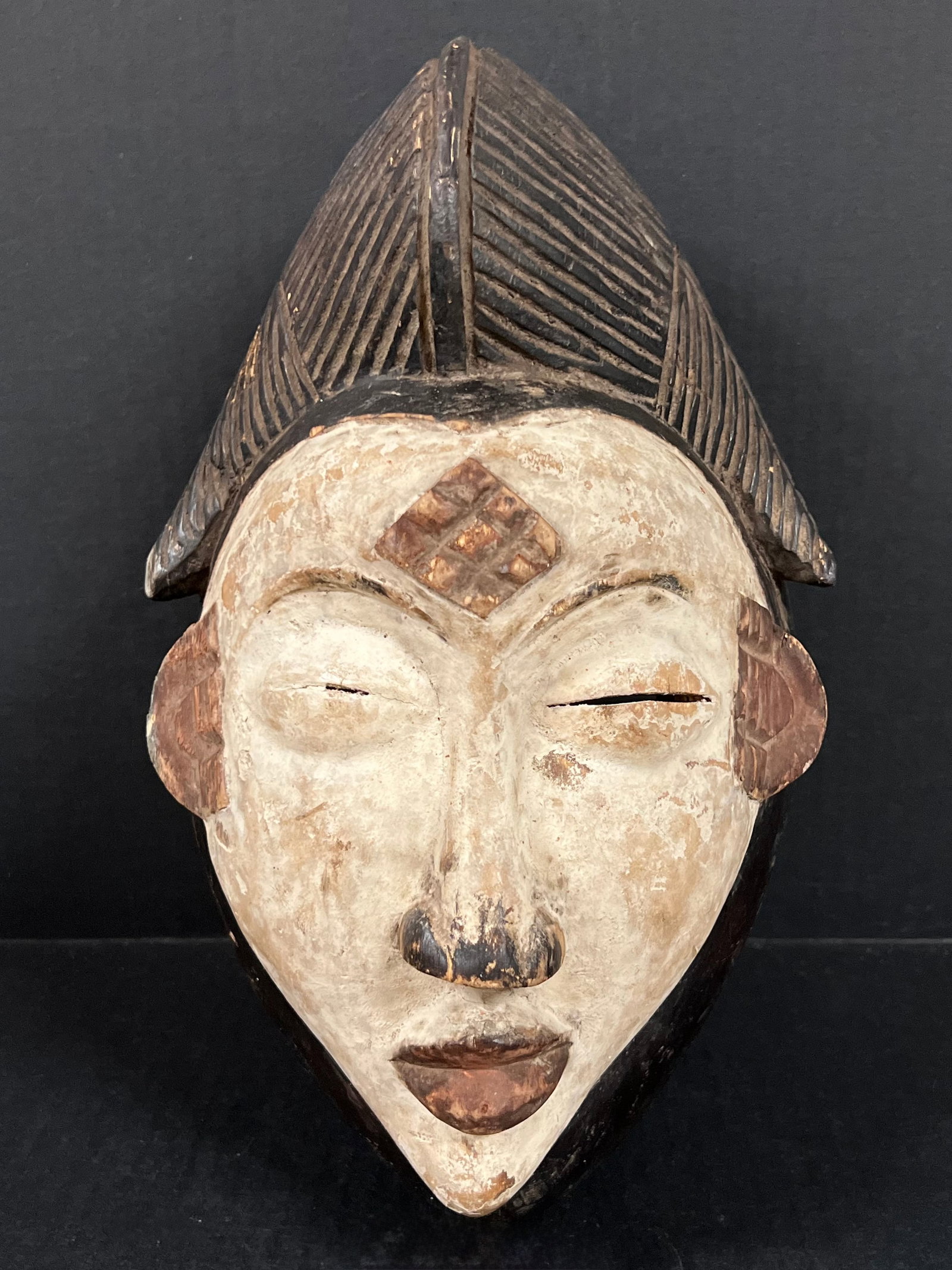 Punu Mask: African Tribal Art Punu Mask. The dimension is 12.5 inches high x 8 inches wide. Please be aware that some of the items are vintage, secondhand, old ages, antiques and may have a defects or sign of
