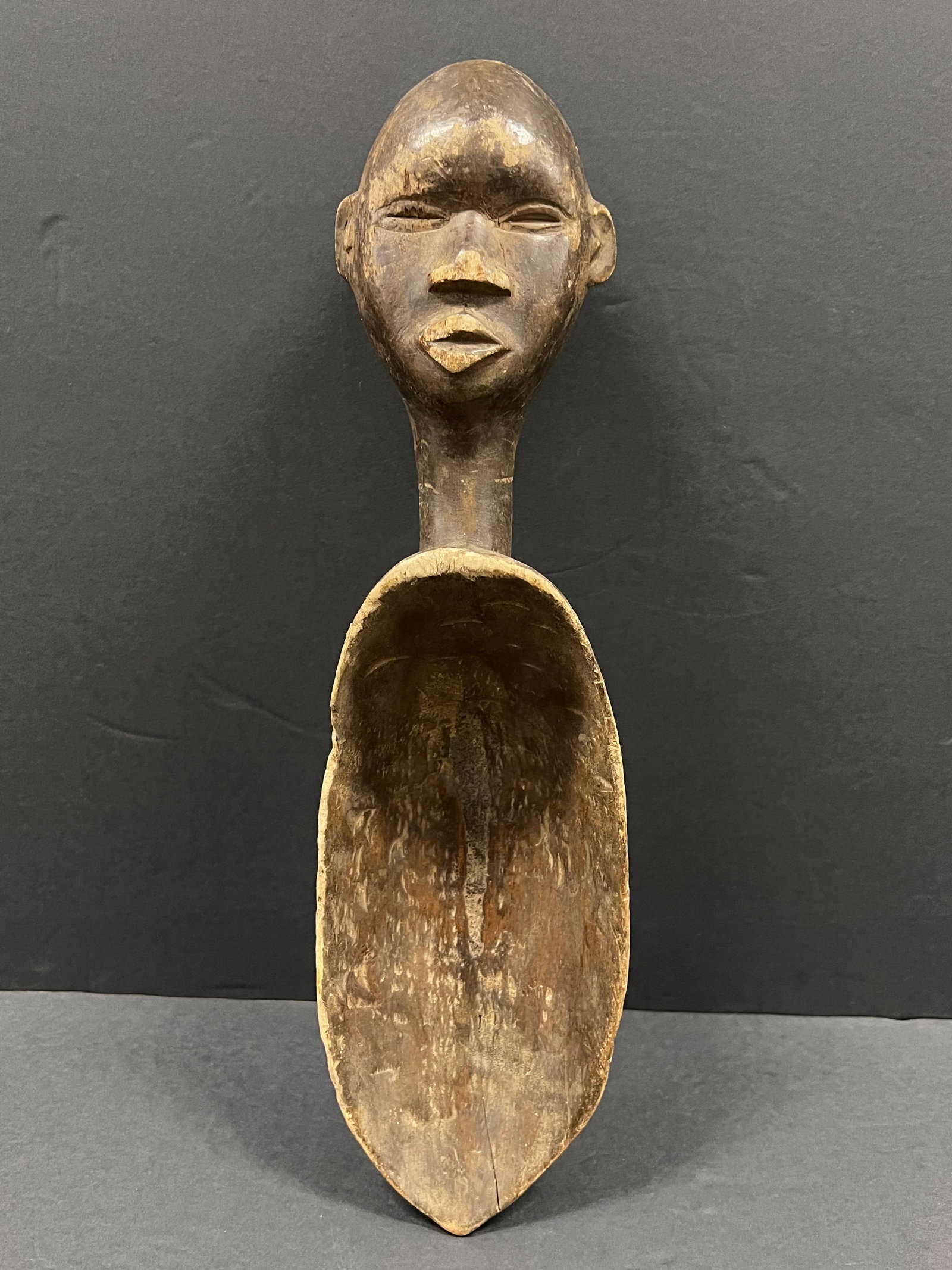 Carved Wood Dan Spoon: African Tribal Art Carved Wood Dan Spoon. The dimension is 17.5 inches high x 5 inches wide. Please be aware that some of the items are vintage, secondhand, old ages, antiques and may have a defects