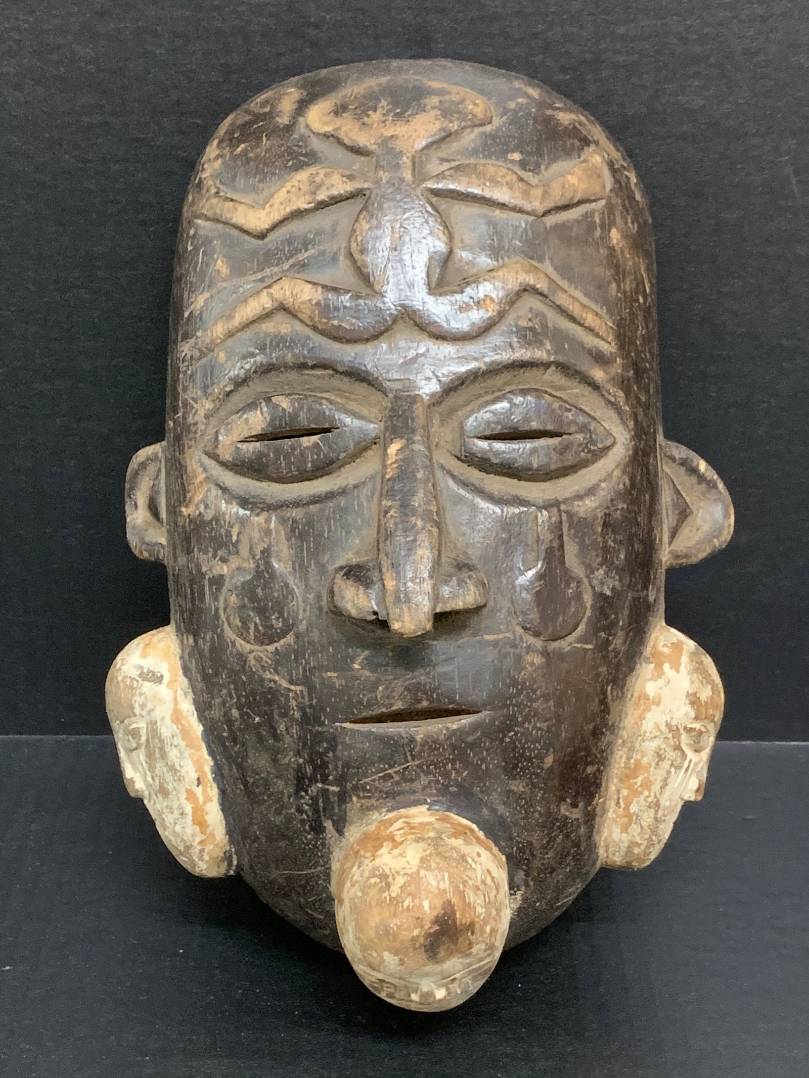 Carved Wood Bacongo Mask: African Tribal Art Carved Wood Bacongo Mask. The dimension is 11 inches high x 7.5 inches wide. Please be aware that some of the items are vintage, secondhand, old ages, antiques and may have a defect
