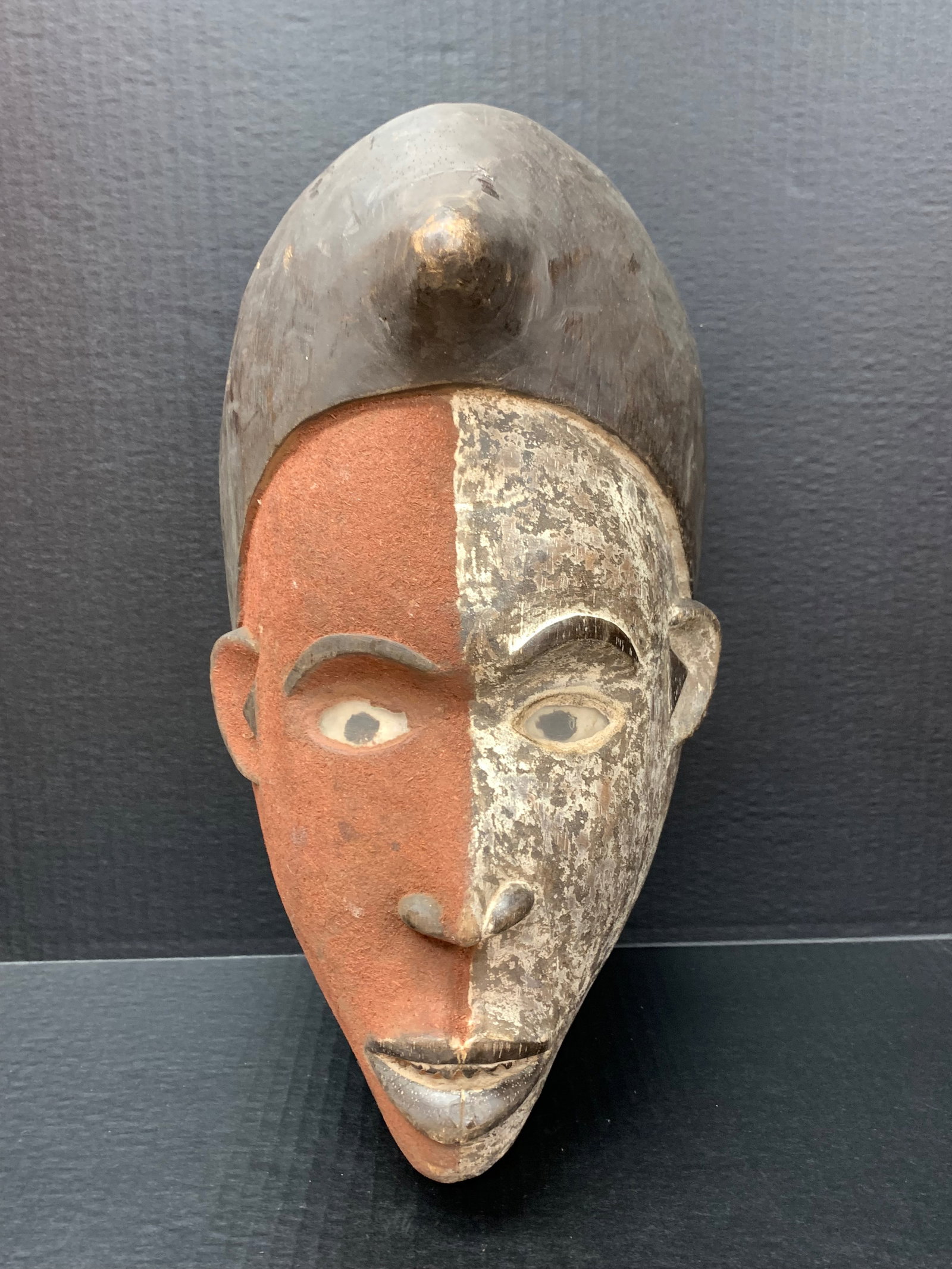 Carved Wood Bacongo Mask: African Tribal Art Carved Wood Bacongo Mask. The dimension is 16 inches high x 5.5 inches wide. Please be aware that some of the items are vintage, secondhand, old ages, antiques and may have a defect