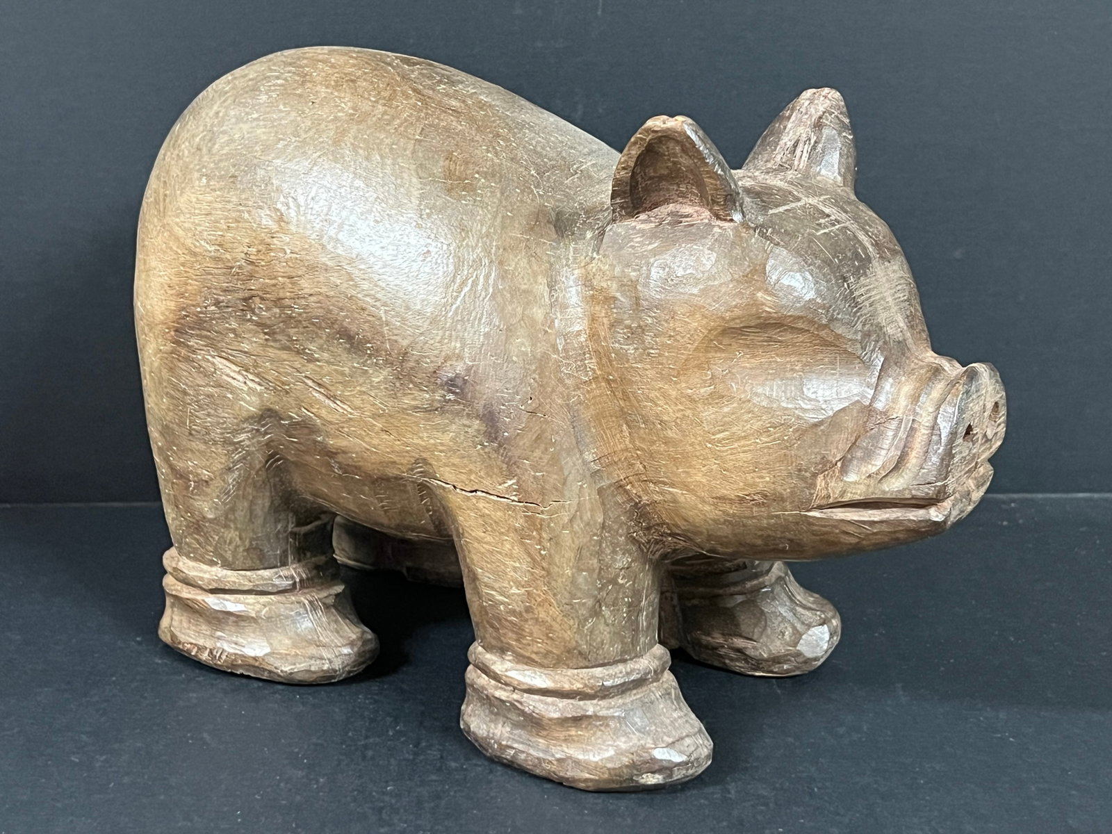 Carved Wood Pig Sculpture: Folk Art Carved Wood Pig Sculpture. The dimension is 8.5 inches high x 12 inches wide. Please be aware that some of the items are vintage, secondhand, old ages, antiques and may have a defects or sign