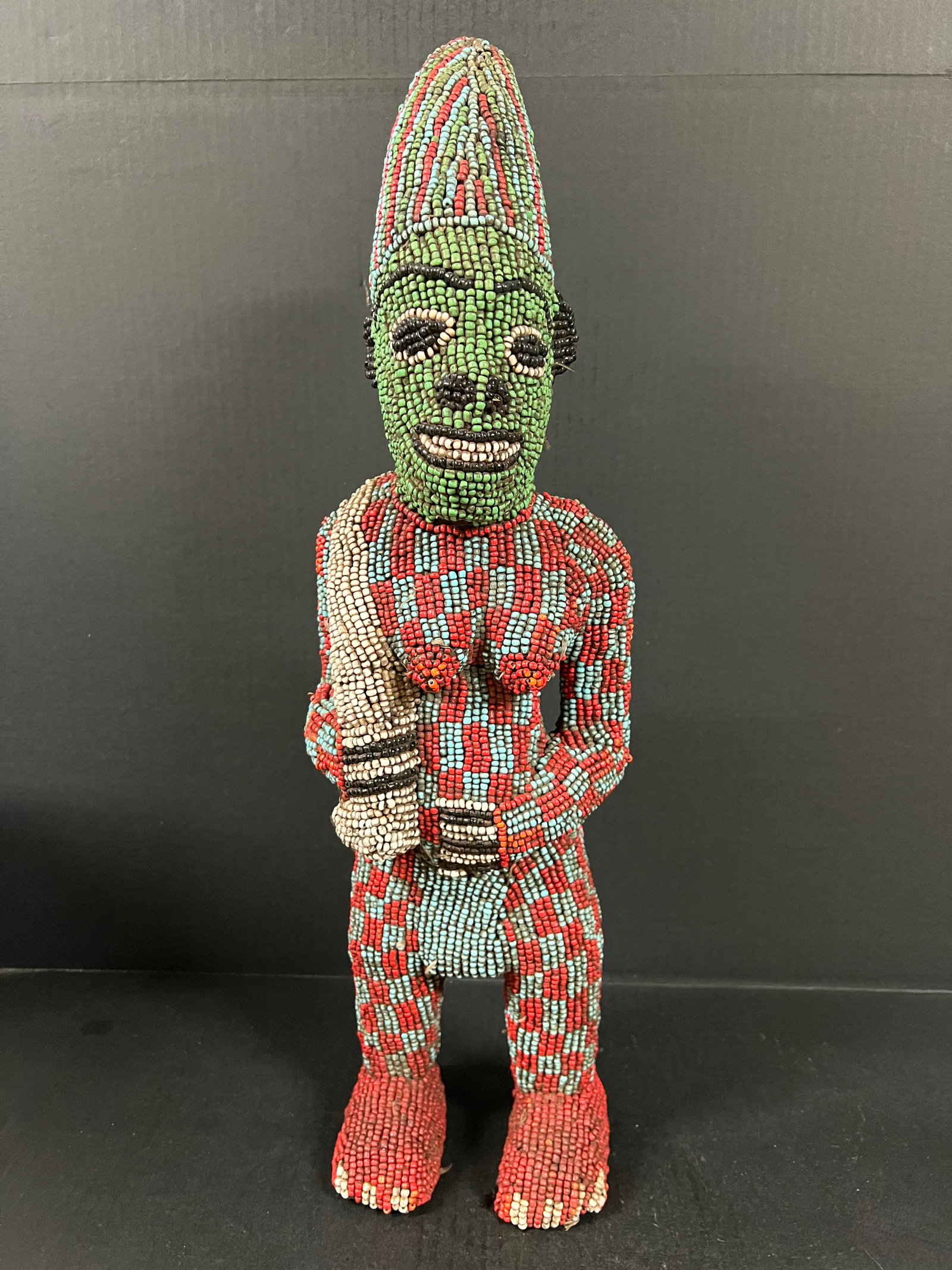 Carved Wood Bamileke Beaded Statue: African Tribal Art Carved Wood Bamileke Beaded Statue. The dimension is 23 inches high x 7 inches wide. Please be aware that some of the items are vintage, secondhand, old ages, antiques and may have