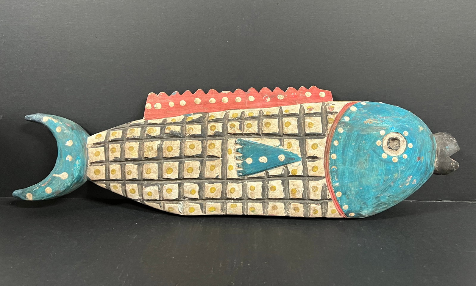 Carved Wood Bozo Puppet Fish: African Tribal Art Carved Wood Bozo Puppet Fish. The dimension is 7.5 inches high x 25 inches long. Please be aware that some of the items are vintage, secondhand, old ages, antiques and may have a