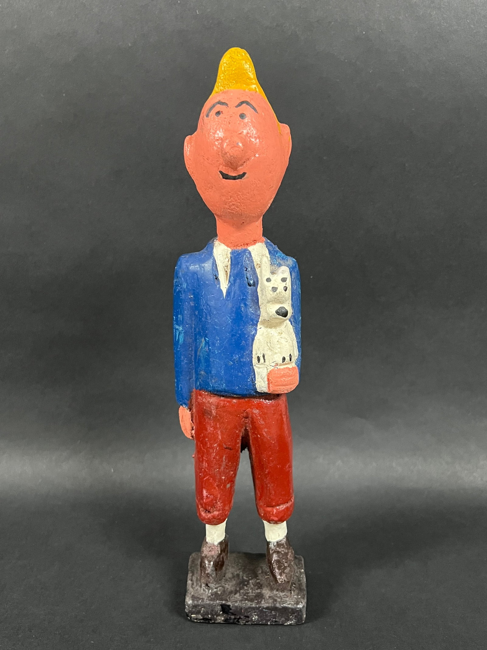 Carved Wood Tintin Colonial Statue: African Tribal Art Carved Wood Tintin Colonial Statue. The dimension is 12 inches high x 3 inches wide. Please be aware that some of the items are vintage, secondhand, old ages, antiques and may have