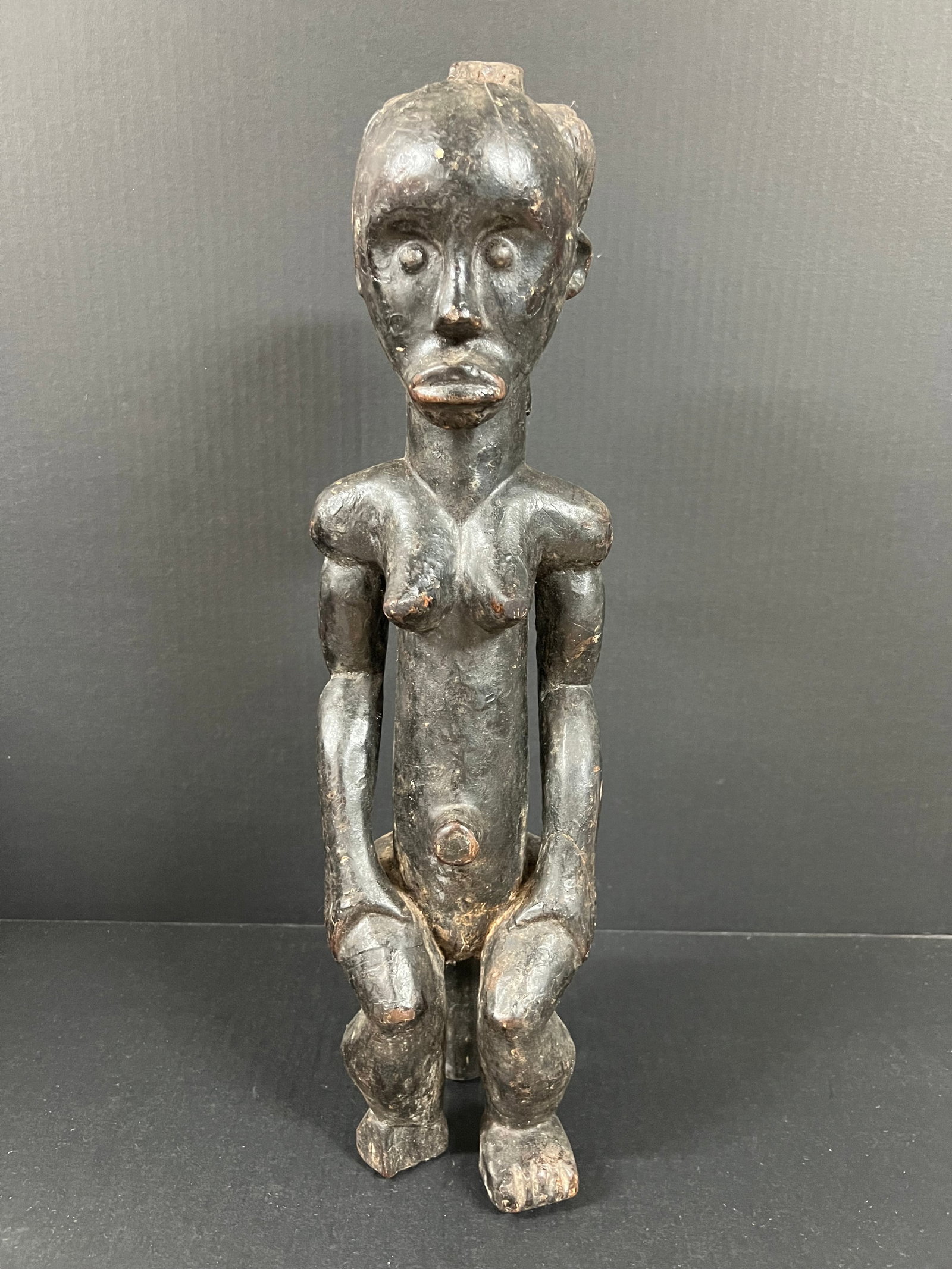 Carved Wood Fang Statue: African Tribal Art Carved Wood Fang Statue. The dimension is 19.5 inches high x 5.5 inches wide. Please be aware that some of the items are vintage, secondhand, old ages, antiques and may have a defec