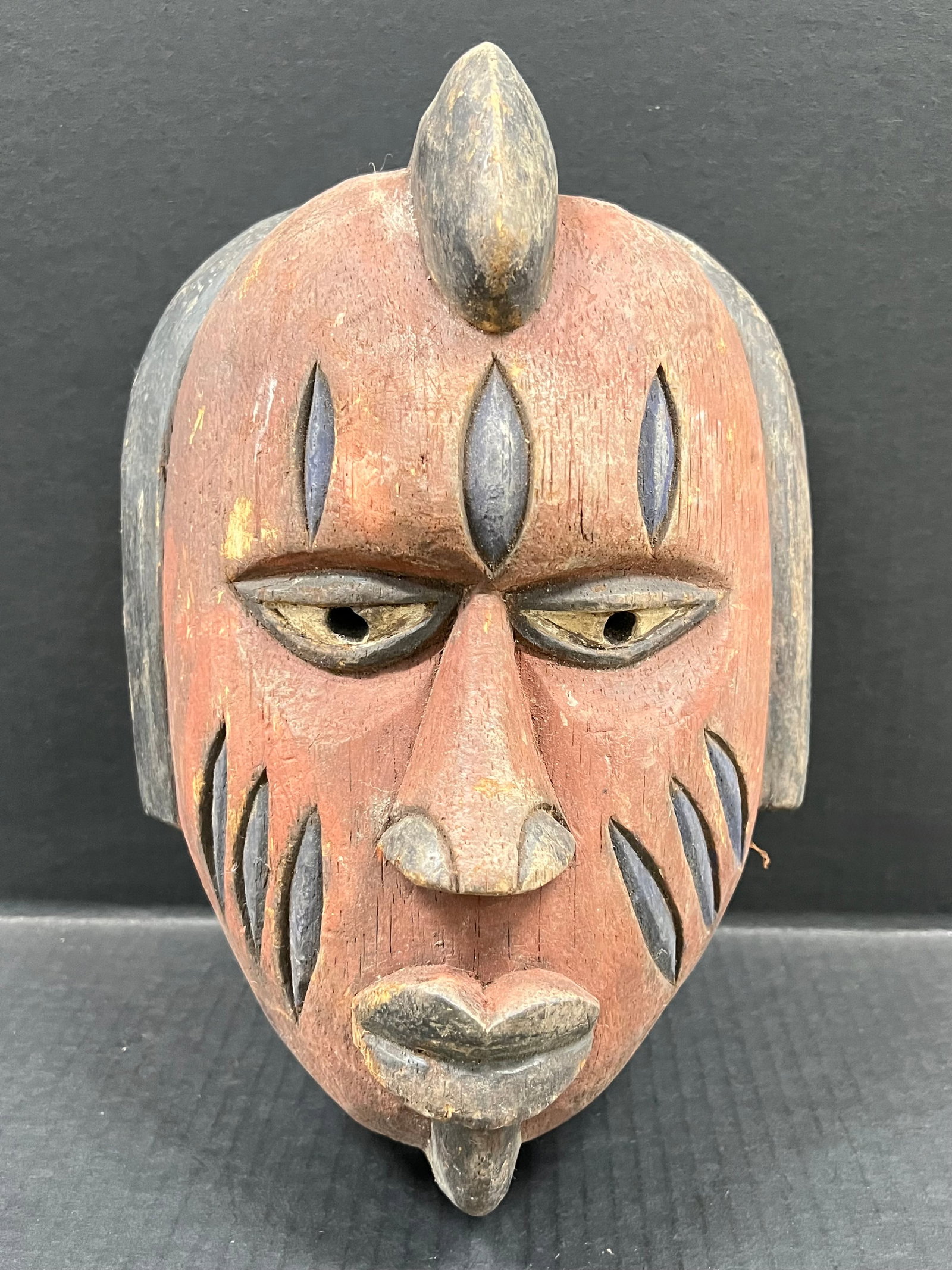 Carved Wood Yoruba Mask: African Tribal Art Carved Wood Yoruba Mask. The dimension is 12 inches high x 9 inches wide. Please be aware that some of the items are vintage, secondhand, old ages, antiques and may have a defects o