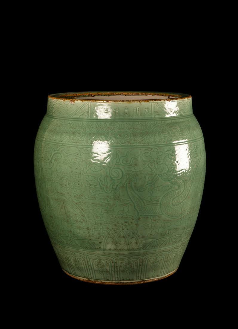 A GELADON-GLAZED DRAGON PATTERN LARGE JAR: Height : 60cm Ming Dynasty. JiaJing six-character marks of the period.