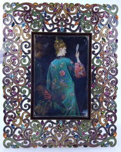 JAY STRONGWATER RETICULATED SCROLLED PICTURE FRAME: Jay Strongwater brass tone metal picture frame having a reticulated openwork scrolled design with enameling and multi-color crystal jewels. Measures approx. 10 1/2" tall x 8 1/2" wide.