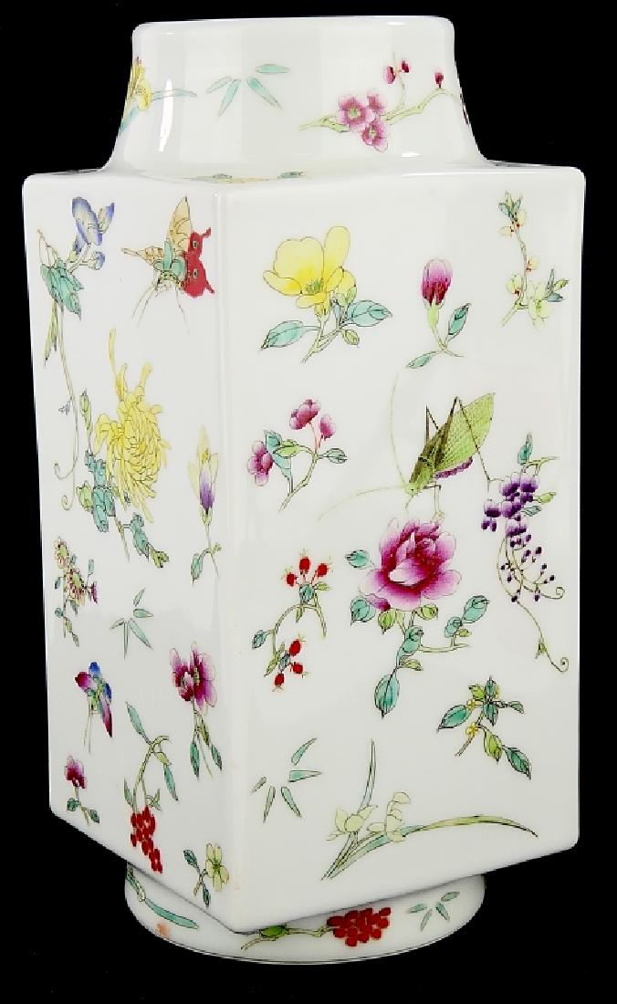 CHINESE FAMILLE ROSE INSECTS FLORAL CONG VASE: Chinese hand painted Famille rose enameled porcelain vase of square cong form depicting butterflies, dragonflies and grass hoppers amongst flowers. Bottom holds red Qianlong nian zhi stamp mark; craft