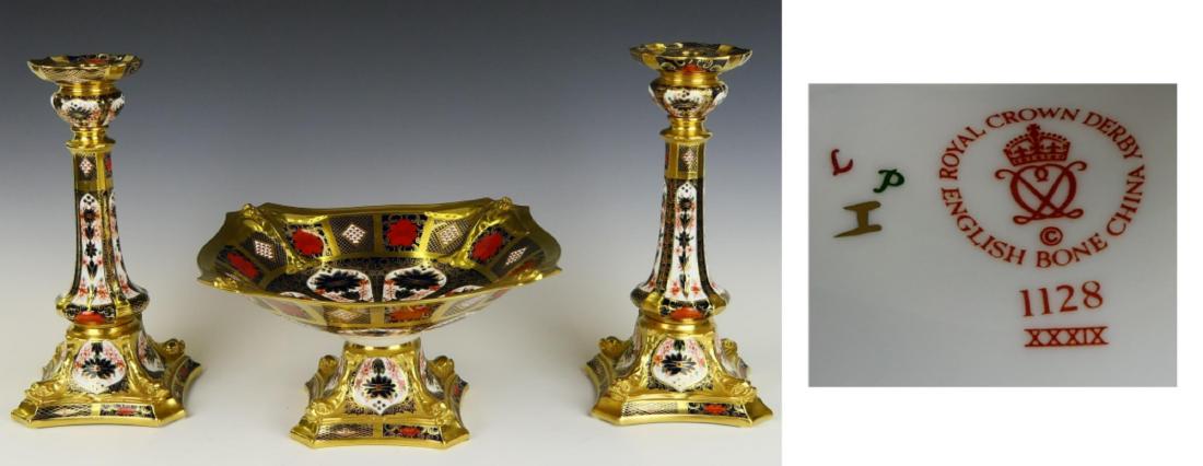3 PIECE ROYAL CROWN DERBY "IMARI" GARNITURE: A wonderful three piece Royal Crown Derby fine English bone porcelain three piece garniture in the ornate "Imari" design with heavy gilt accenting. Set is to include a footed compote and a pair of can