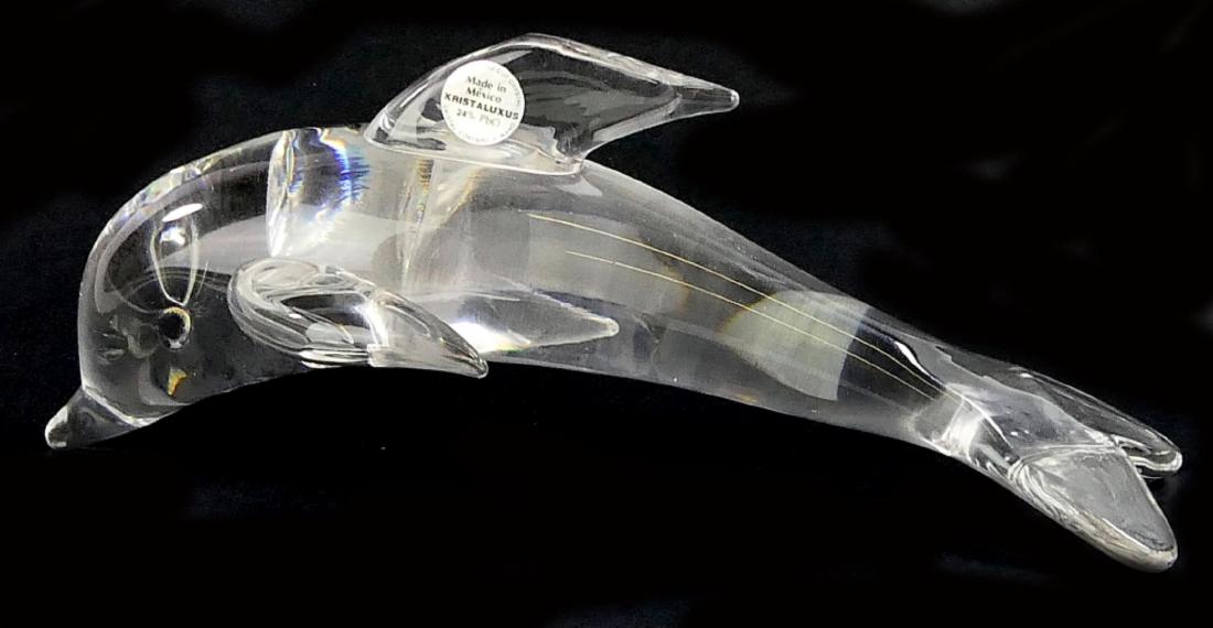 KRISTALUXUS LEAD CRYSTAL DOLPHIN SCULPTURE: A Kristaluxus Mexican hand blown leaded crystal animal sculpture depicting a dolphin. Has label to side of fin. Measures approx. 10 3/4" length x 4 1/4" height x 4 1/2" width. shipping $ 49 plus ins u