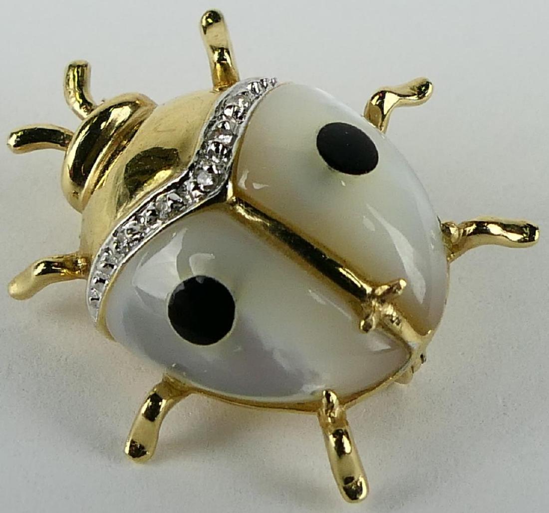 14 KT Y GOLD MOONSTONE & DIAMOND BEETLE PIN: Measures about .50" with small round brilliant diamond accent , body is moonstone with black enamel total weight 3.7 grams, from a local estate shipping $25 plus insurance U.S.